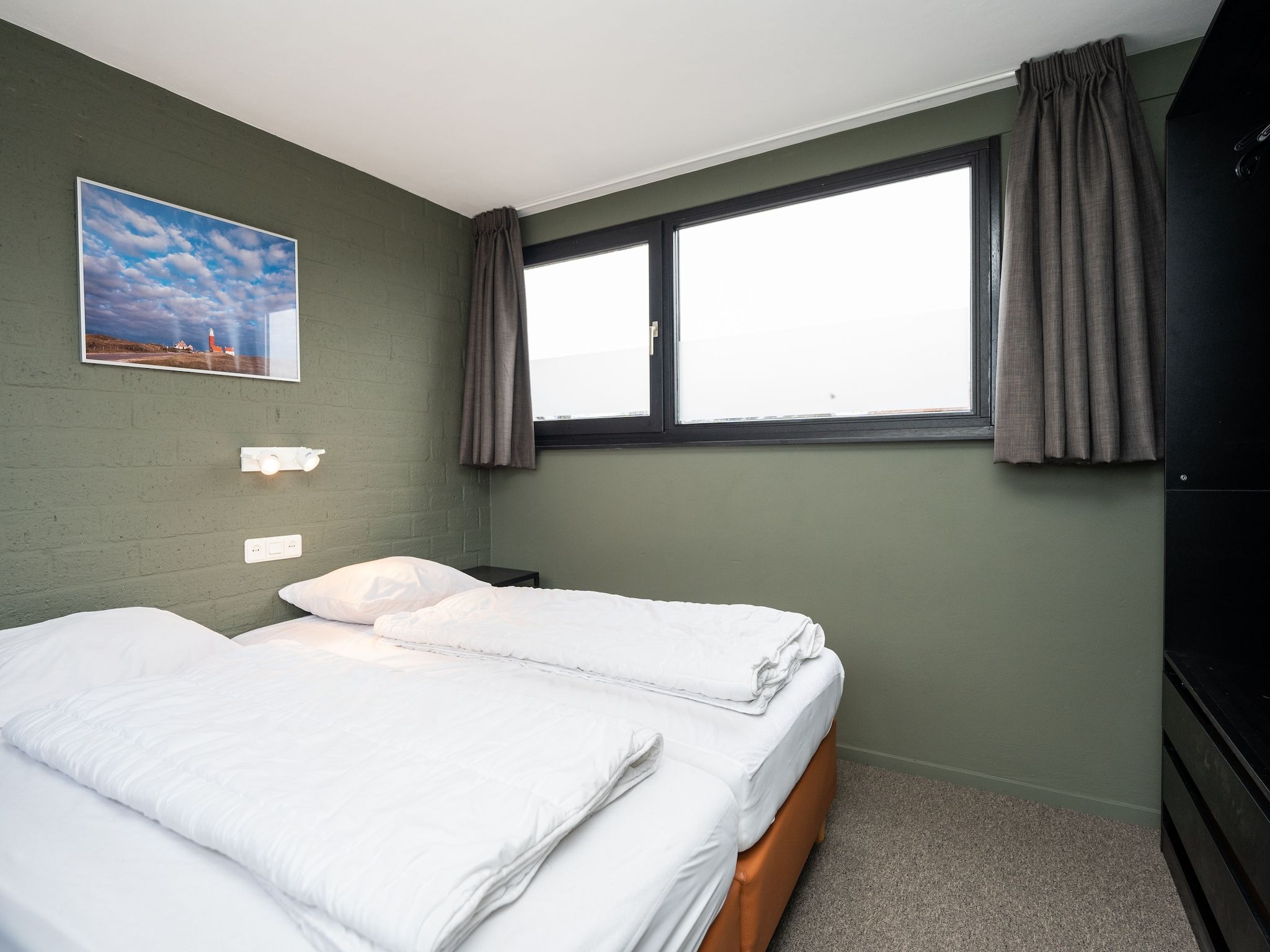 Een slaapkamer van Vakantiepark 't Eibernest Texel 5 in De Cocksdorp