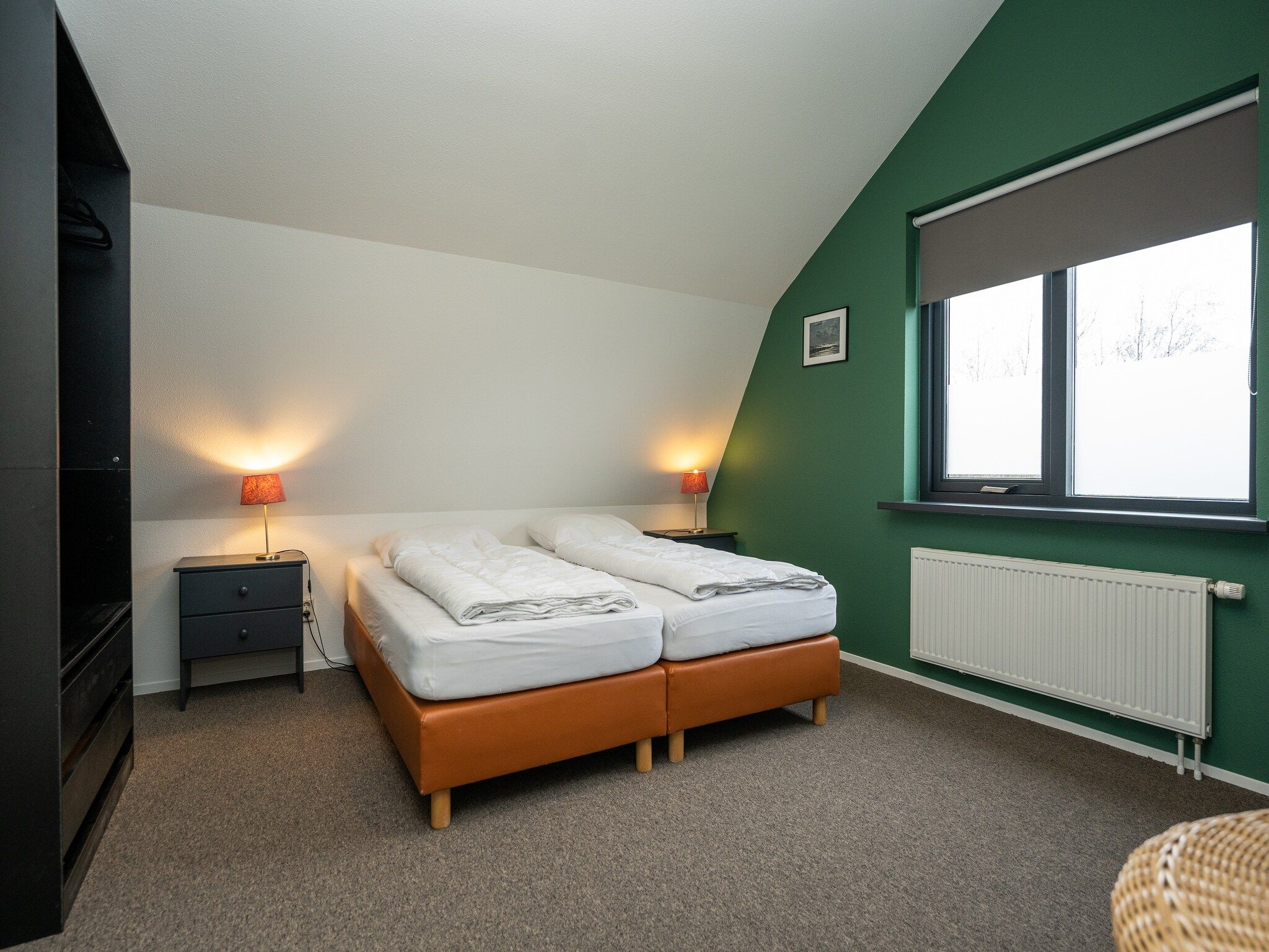 Een slaapkamer van Vakantiepark 't Eibernest Texel 7 in De Cocksdorp