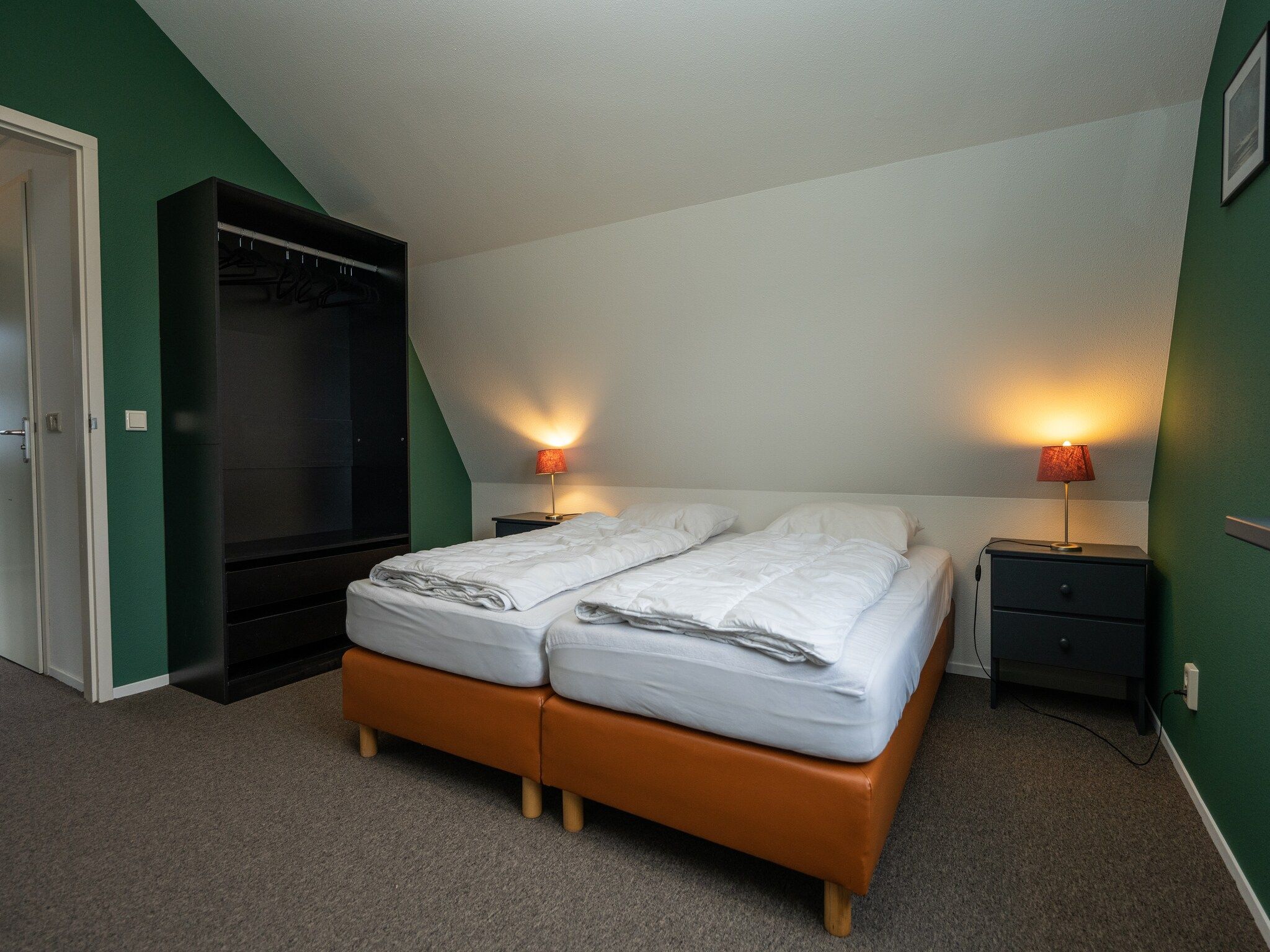 Een slaapkamer van Vakantiepark 't Eibernest Texel 7 in De Cocksdorp