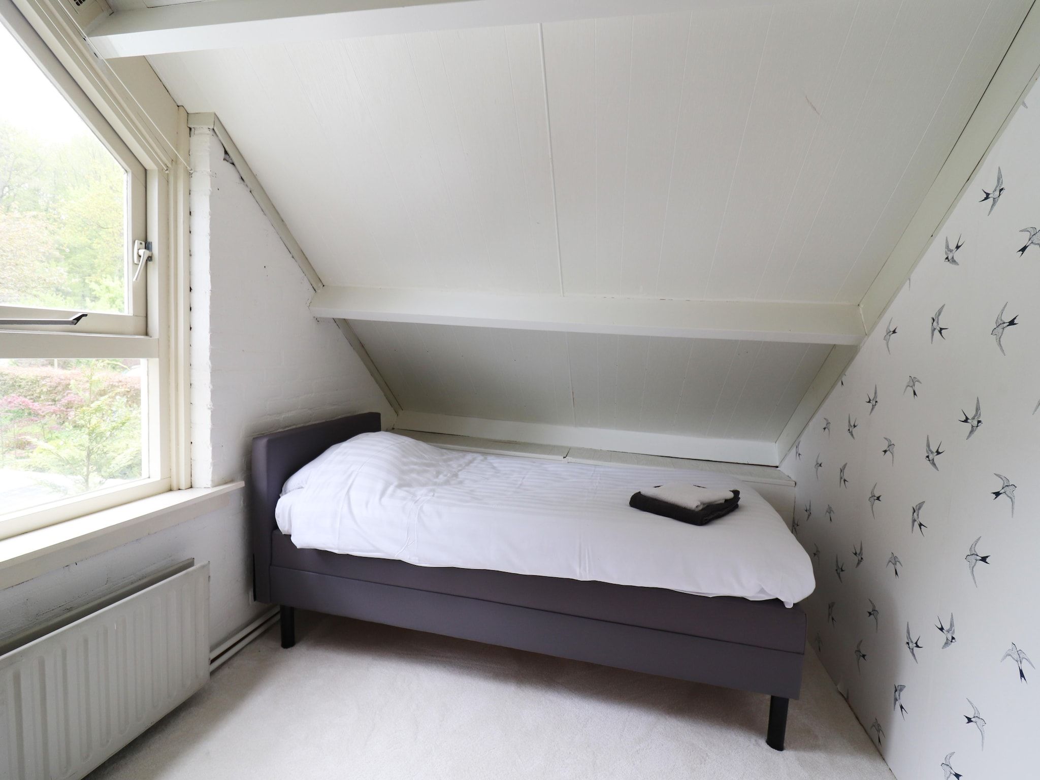 Een slaapkamer van Boshuisje De Koolmees in Appelscha