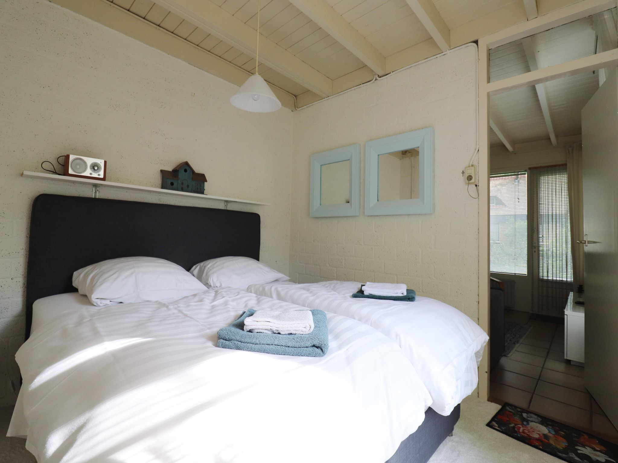 Een slaapkamer van Boshuisje De Koolmees in Appelscha