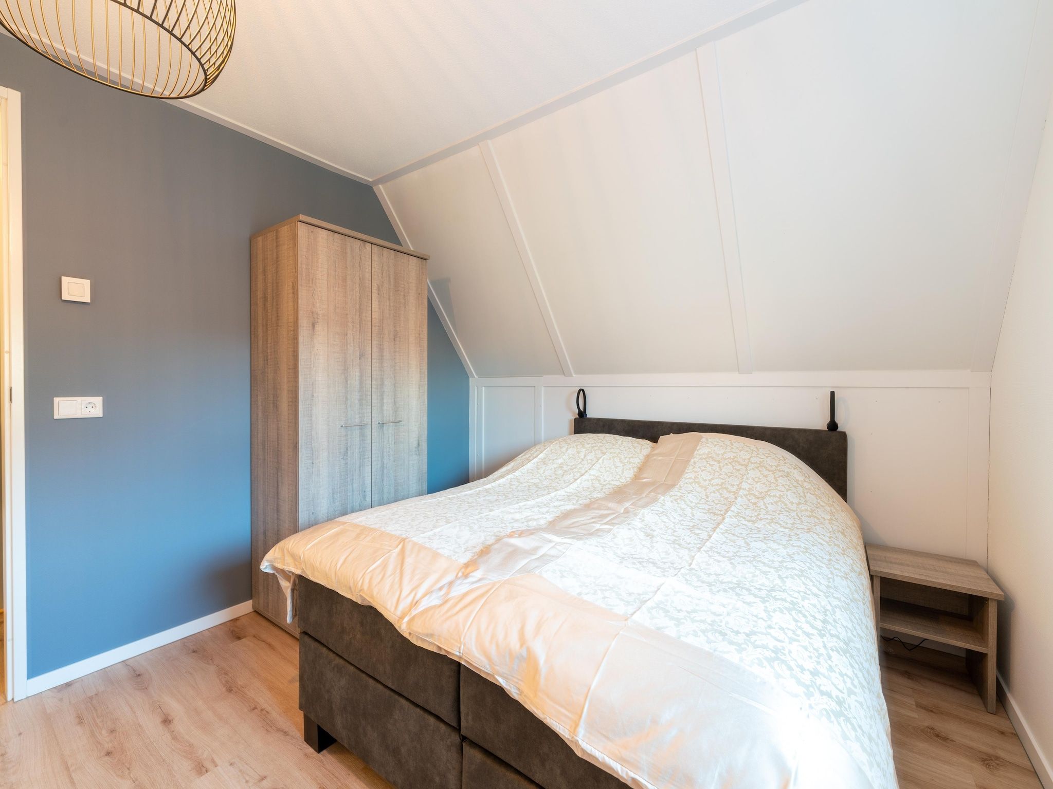 Een slaapkamer van De Ooievaar Huis NR 23 in Scherpenisse