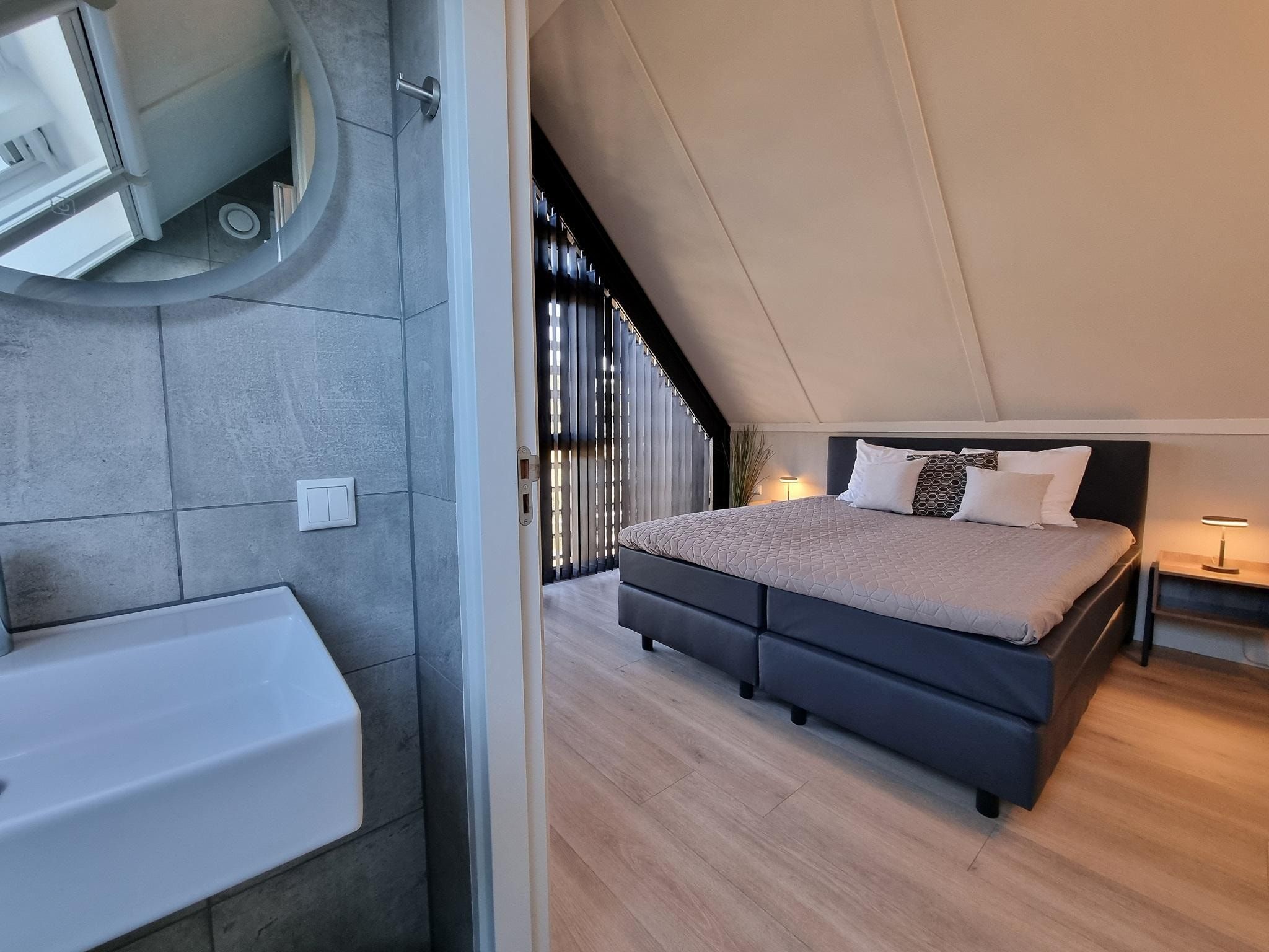 Een slaapkamer van Watervilla Tolve in Balk