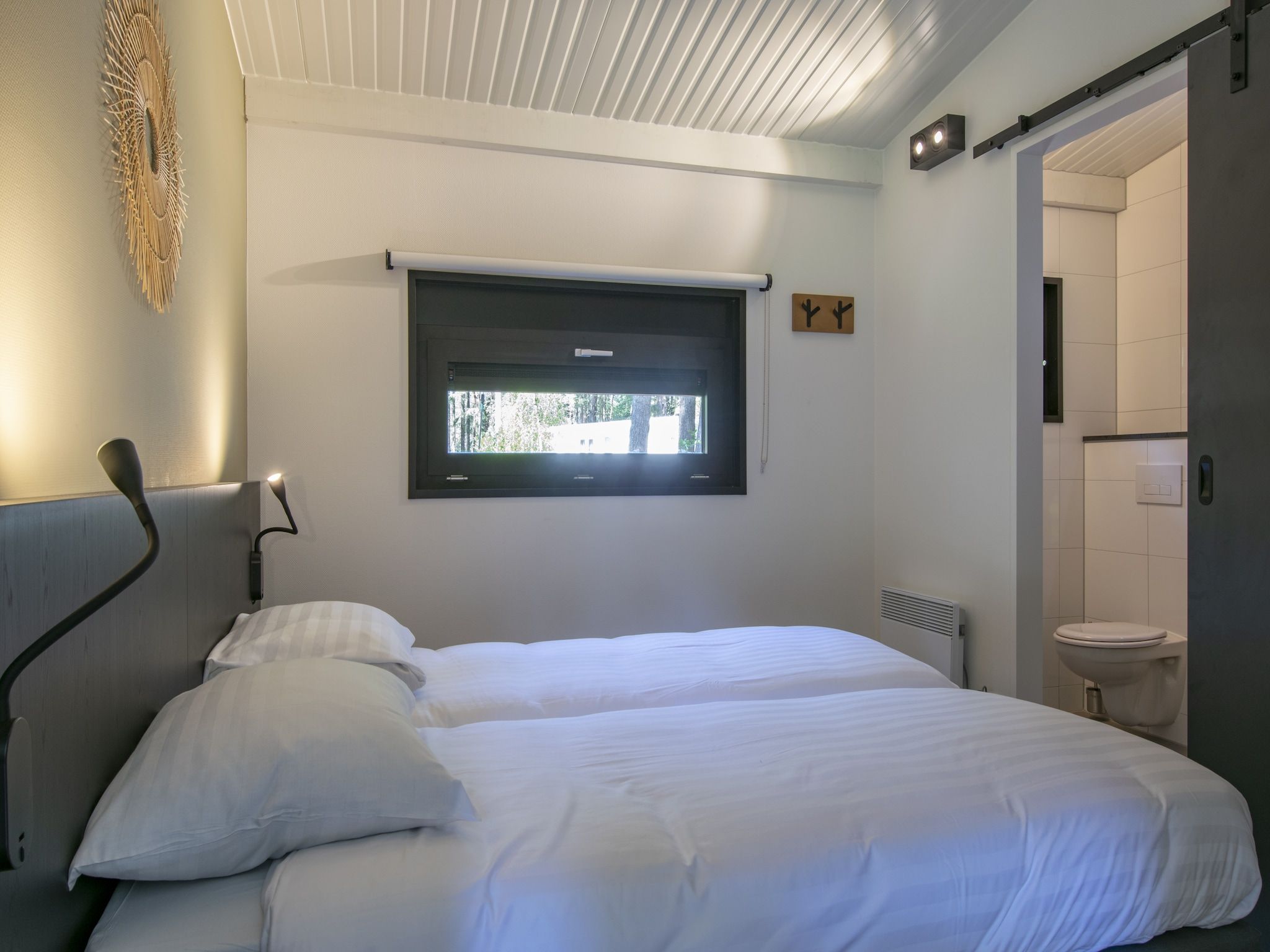 Een slaapkamer van Bospark 't Wolfsven 17 in Mierlo