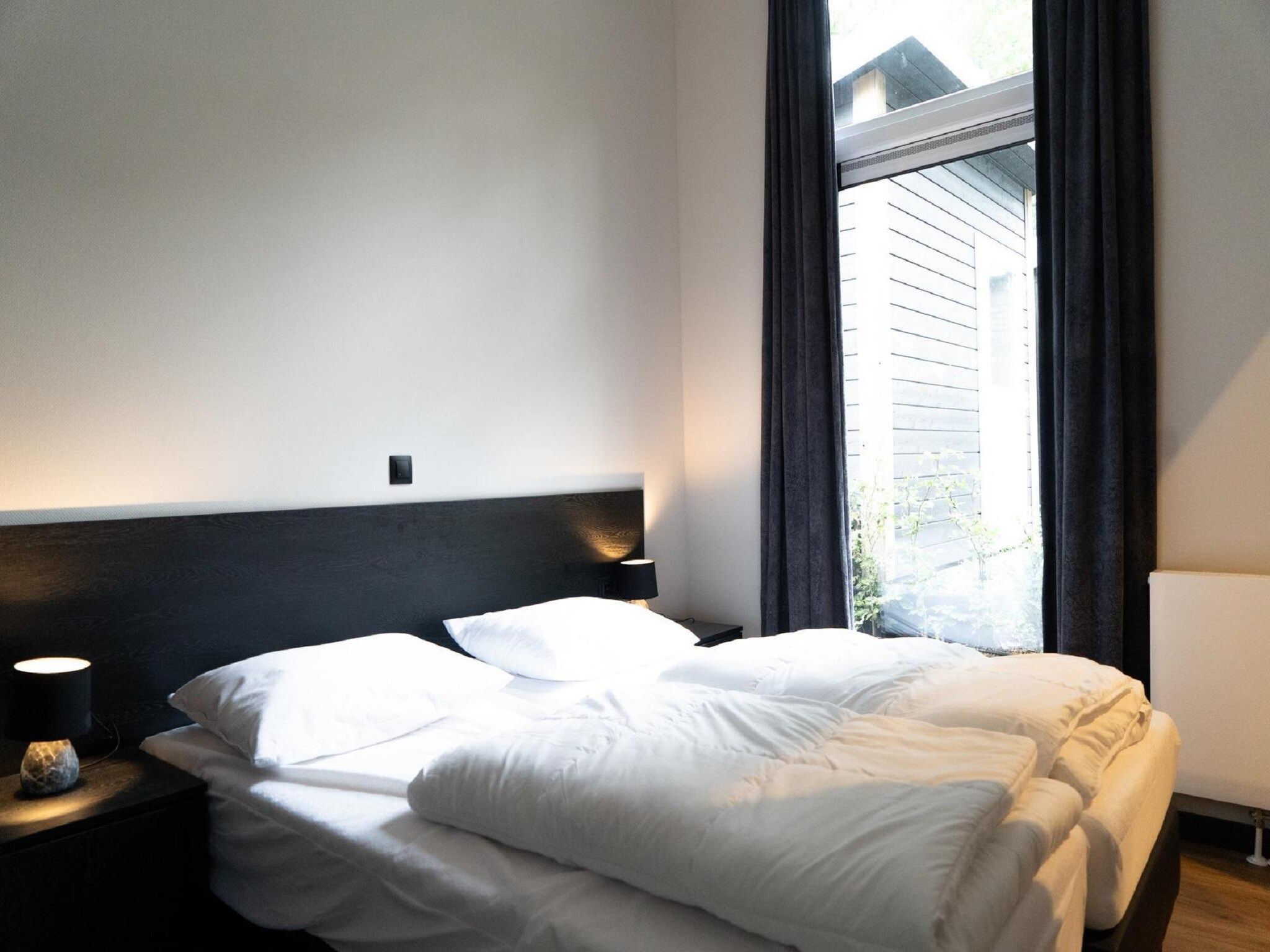 Een slaapkamer van Vakantiepark De Rimboe & De Woeste Hoogte 39 in Hoenderloo