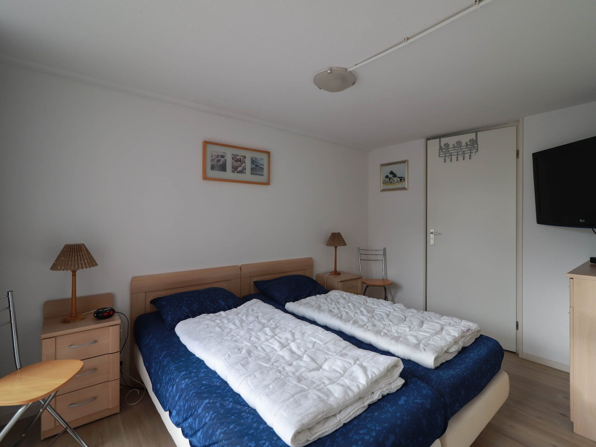 Een slaapkamer van Duinvilla Deluxe met Sauna - 8 personen in Makkum