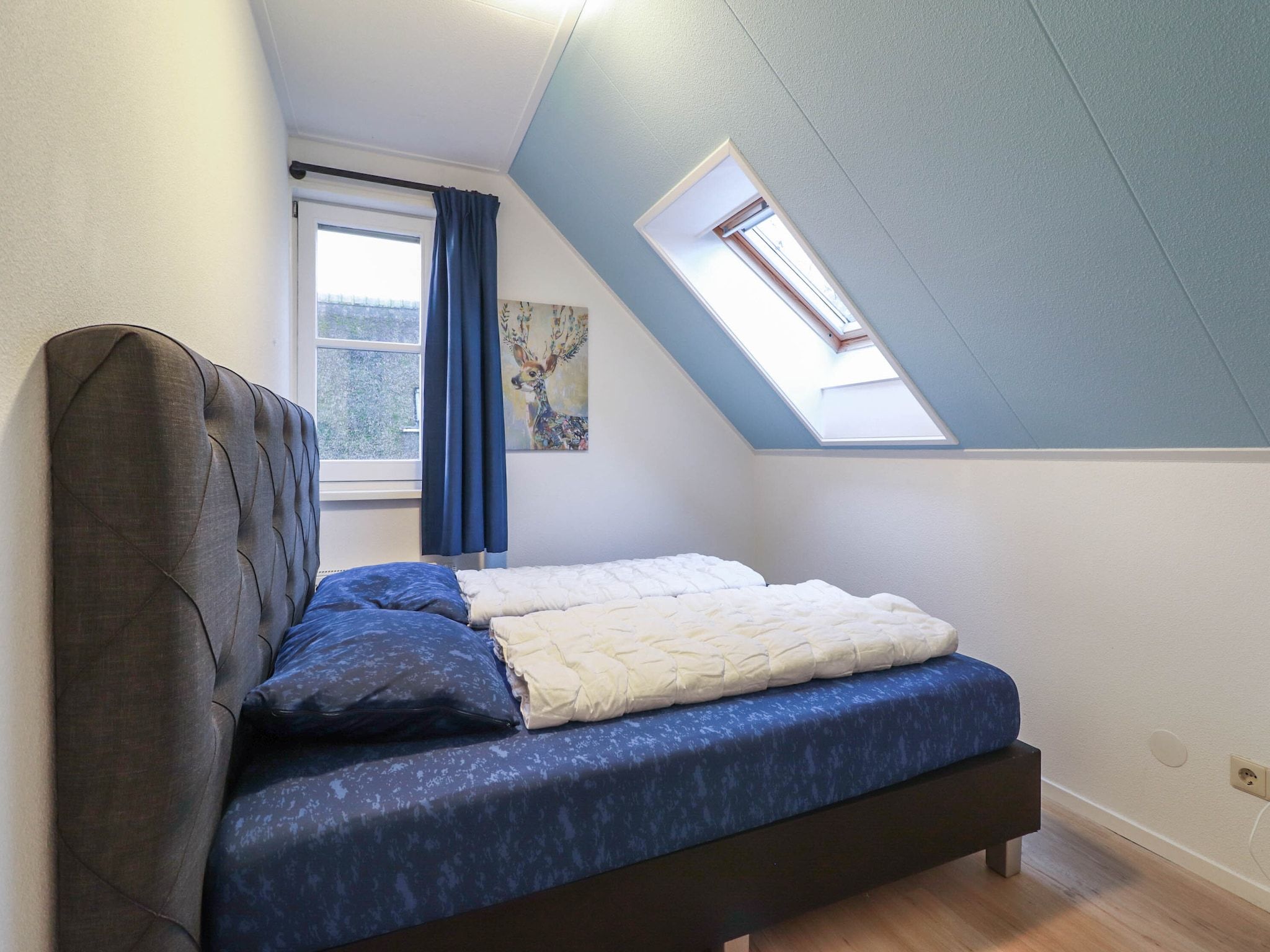 Een slaapkamer van Duinvilla Deluxe met Sauna - 8 personen in Makkum