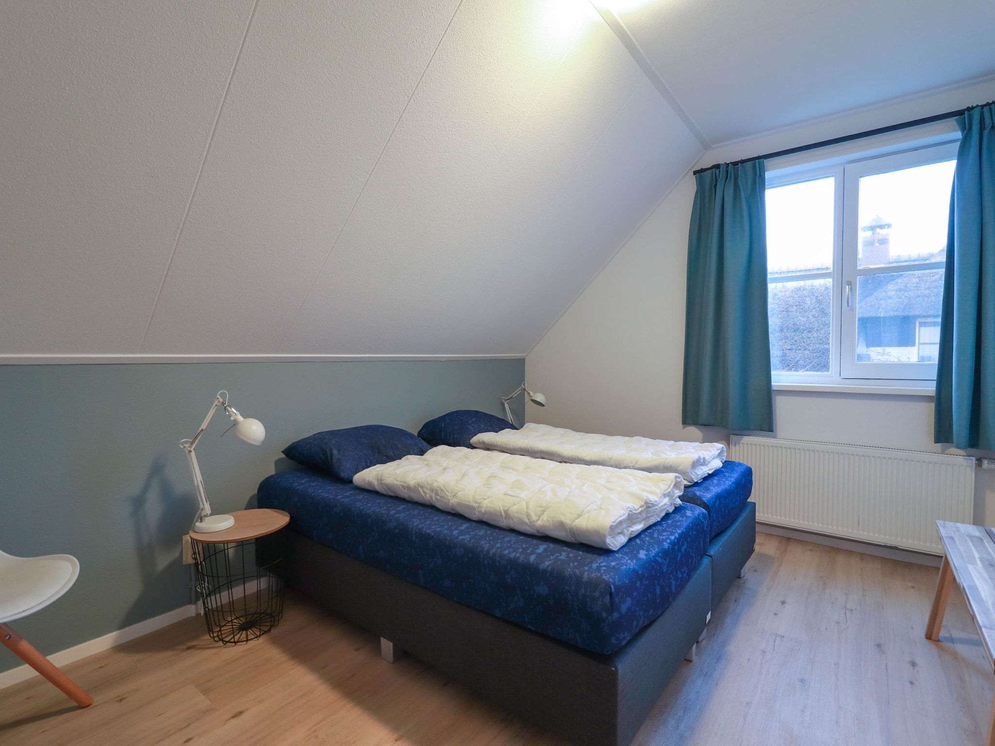 Een slaapkamer van Duinvilla Deluxe met Sauna - 8 personen in Makkum