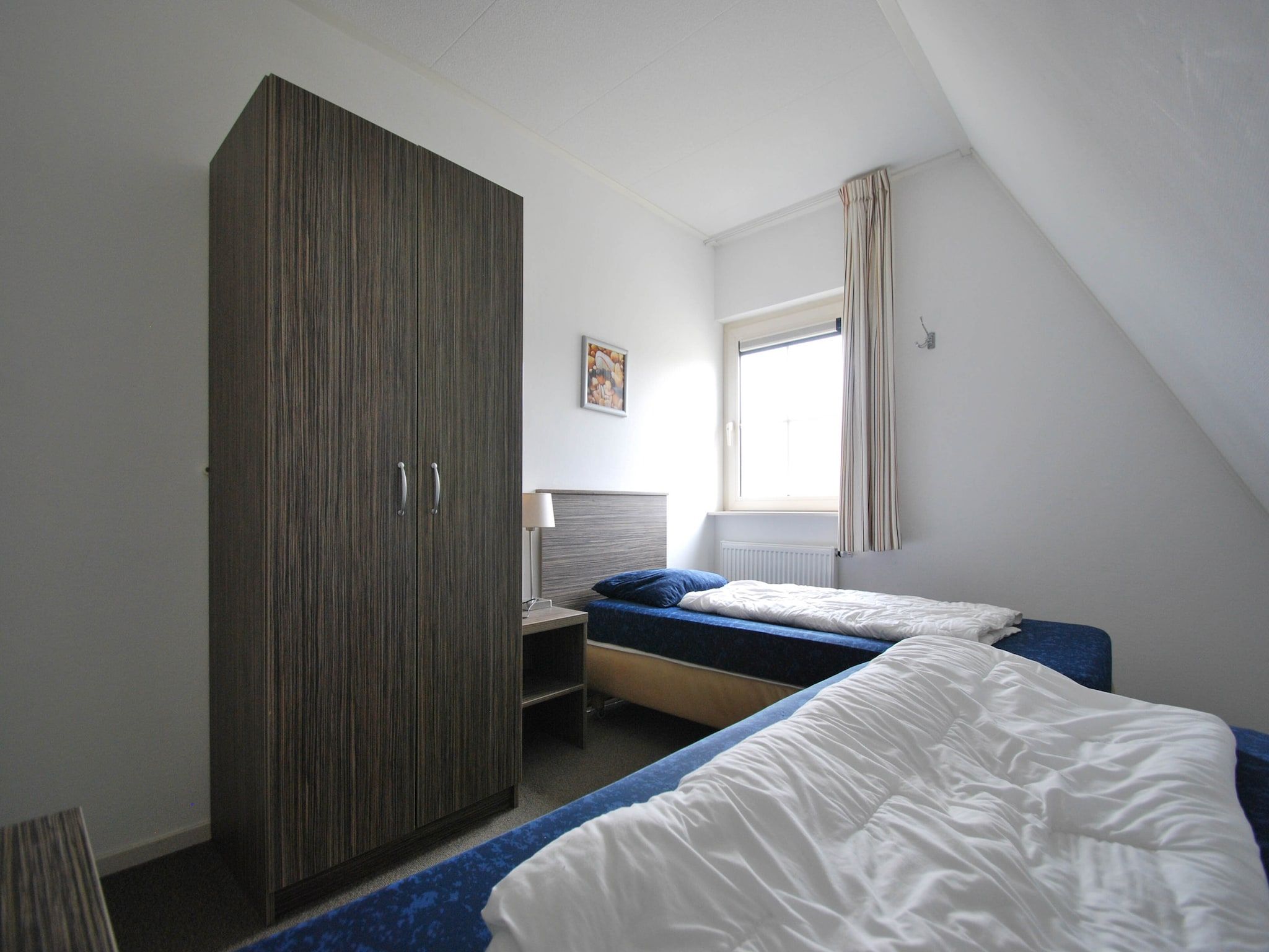 Een slaapkamer van Beachvilla Royaal met Sauna - 10 personen in Makkum