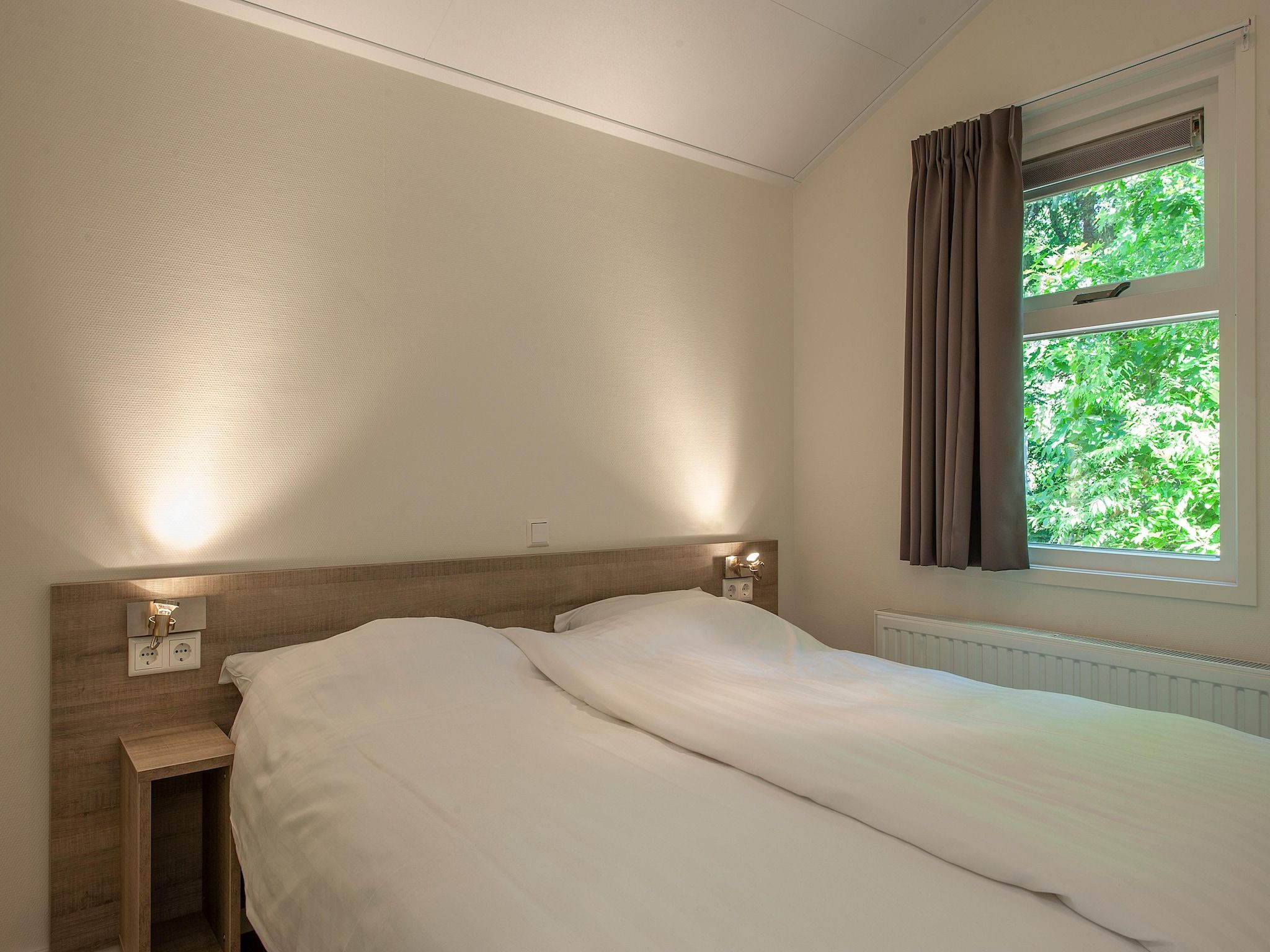 Een slaapkamer van Bospark de Schaapskooi 10 in Wissel/Epe