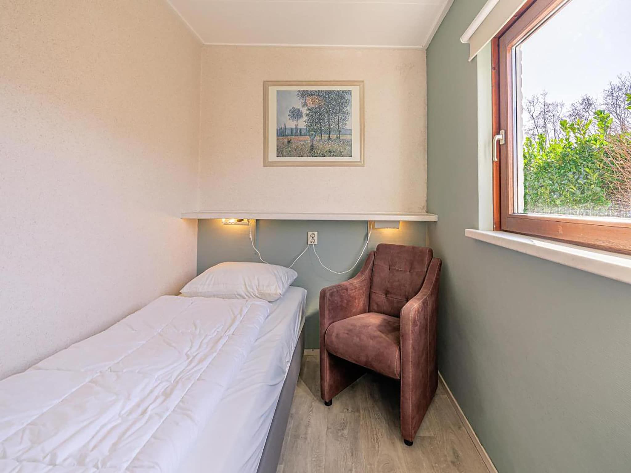 Een slaapkamer van De Parel 166 in Den Burg