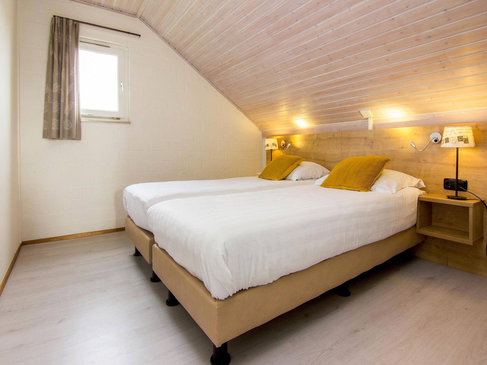 Een slaapkamer van Vakantiepark Reevallis 7 in Vijlen
