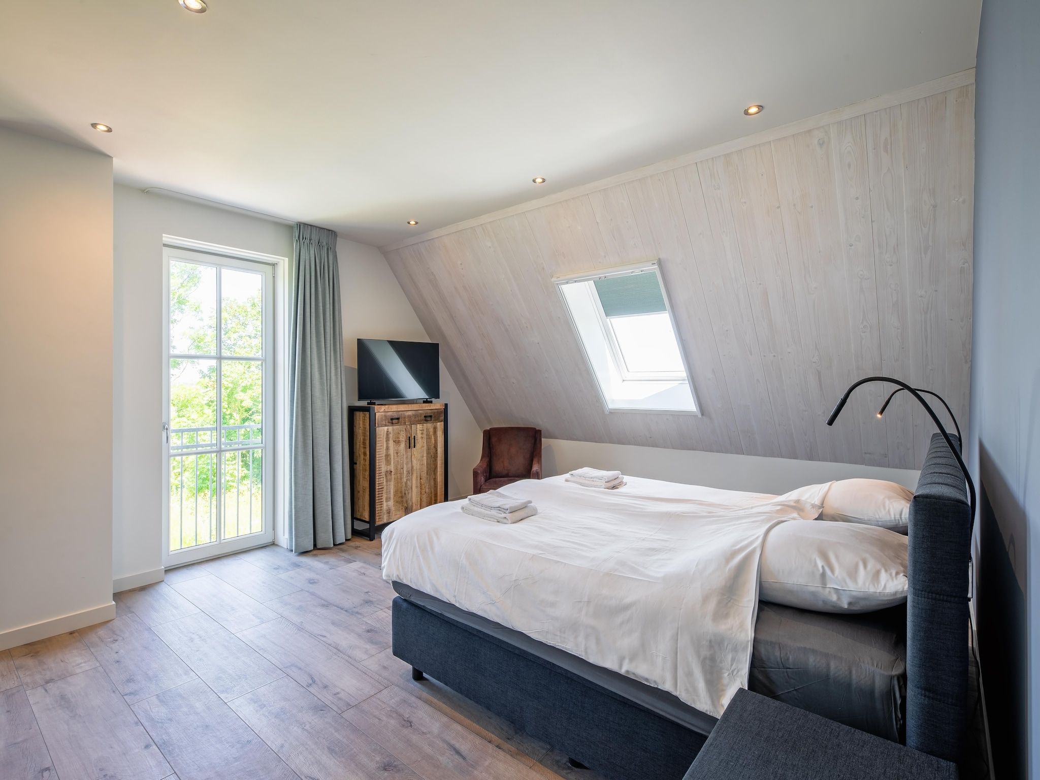 Een slaapkamer van Familievilla Nieuw-Zeeland in Oosterend