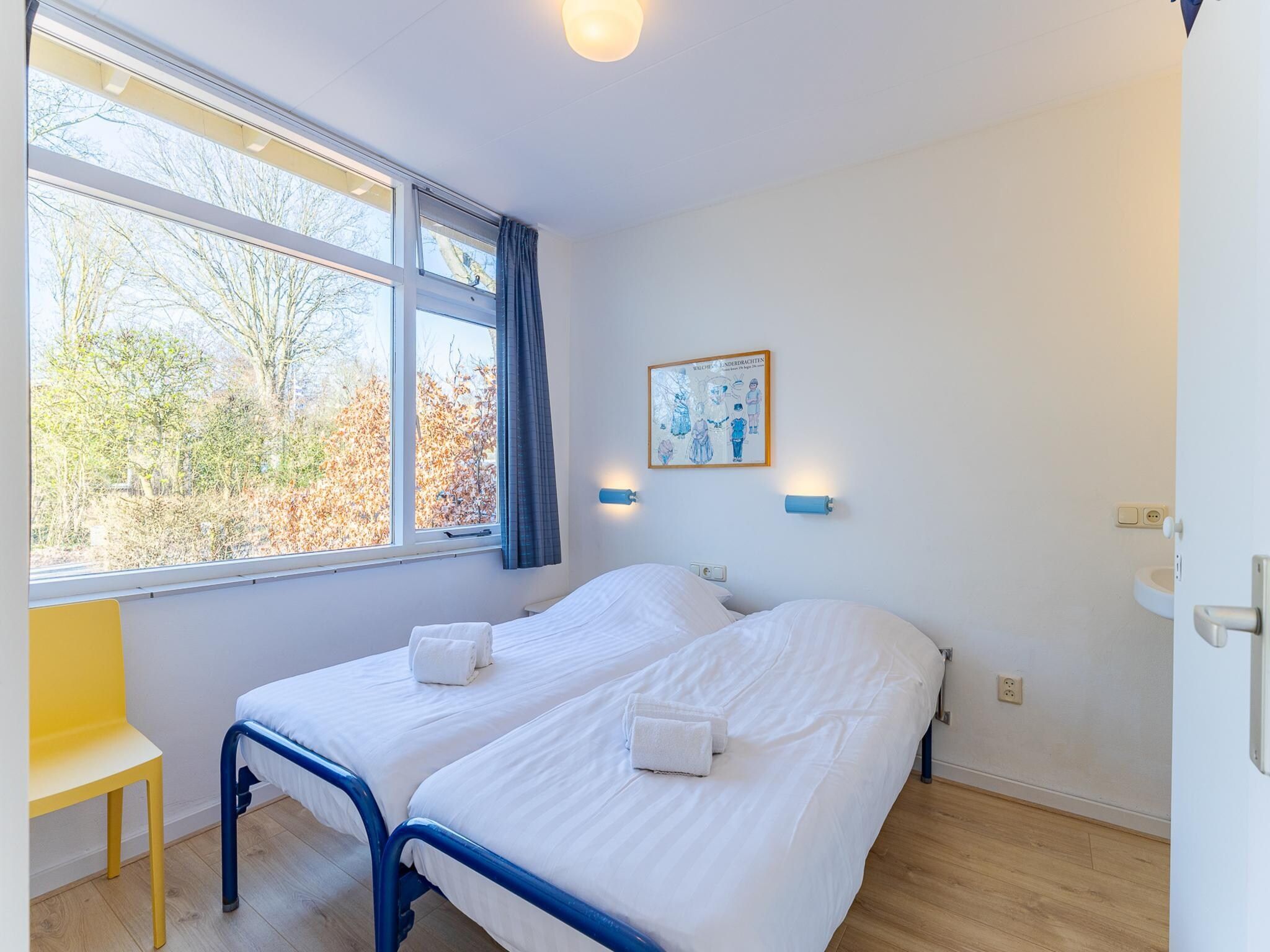 Een slaapkamer van Vakantiehuis - Oosterpark 77 - Oostkapelle in Oostkapelle