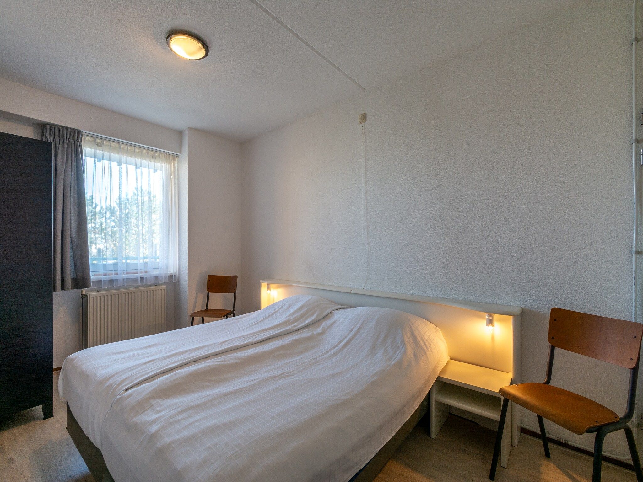 Een slaapkamer van Strandslag 127 in Julianadorp aan Zee