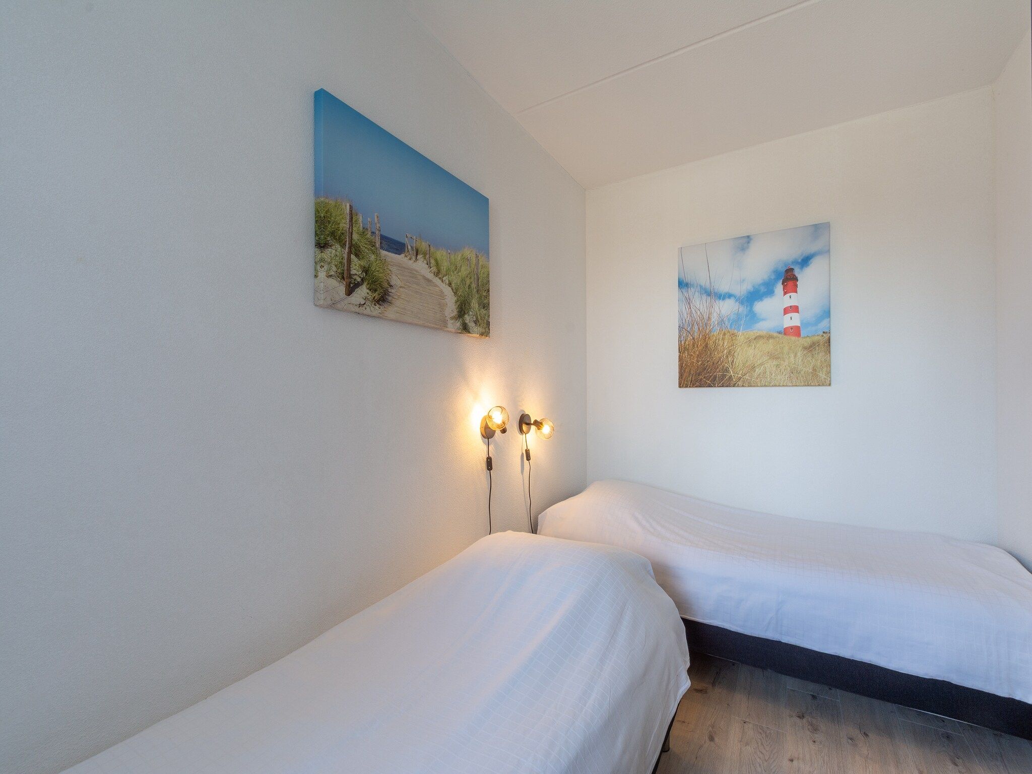 Een slaapkamer van Strandslag 127 in Julianadorp aan Zee