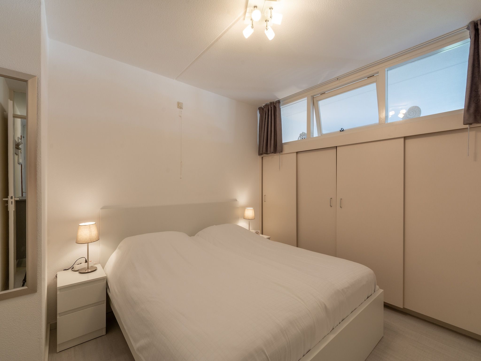 Een slaapkamer van Strandslag 195 in Julianadorp aan Zee