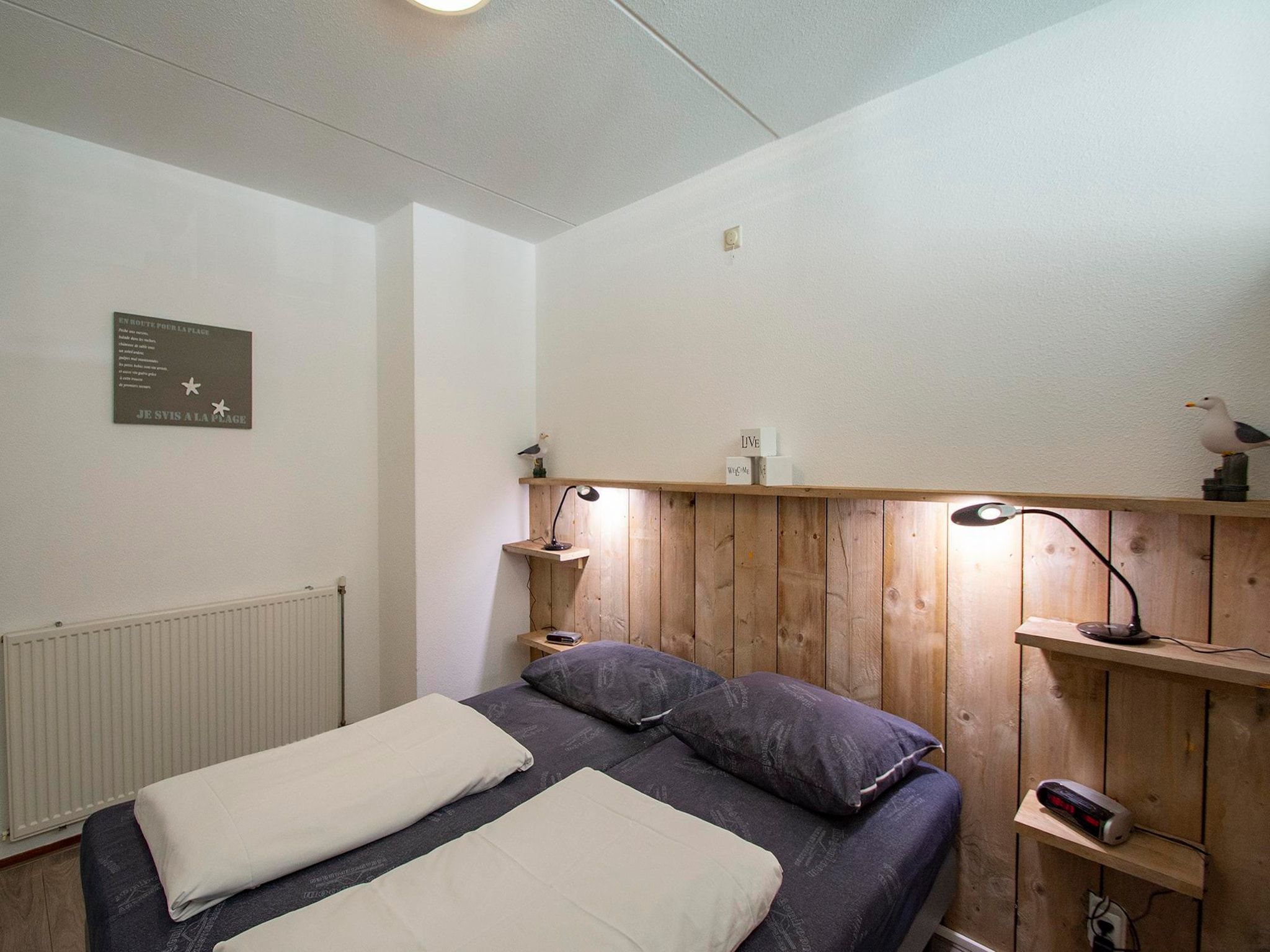 Een slaapkamer van Strandslag 215 in Julianadorp aan Zee