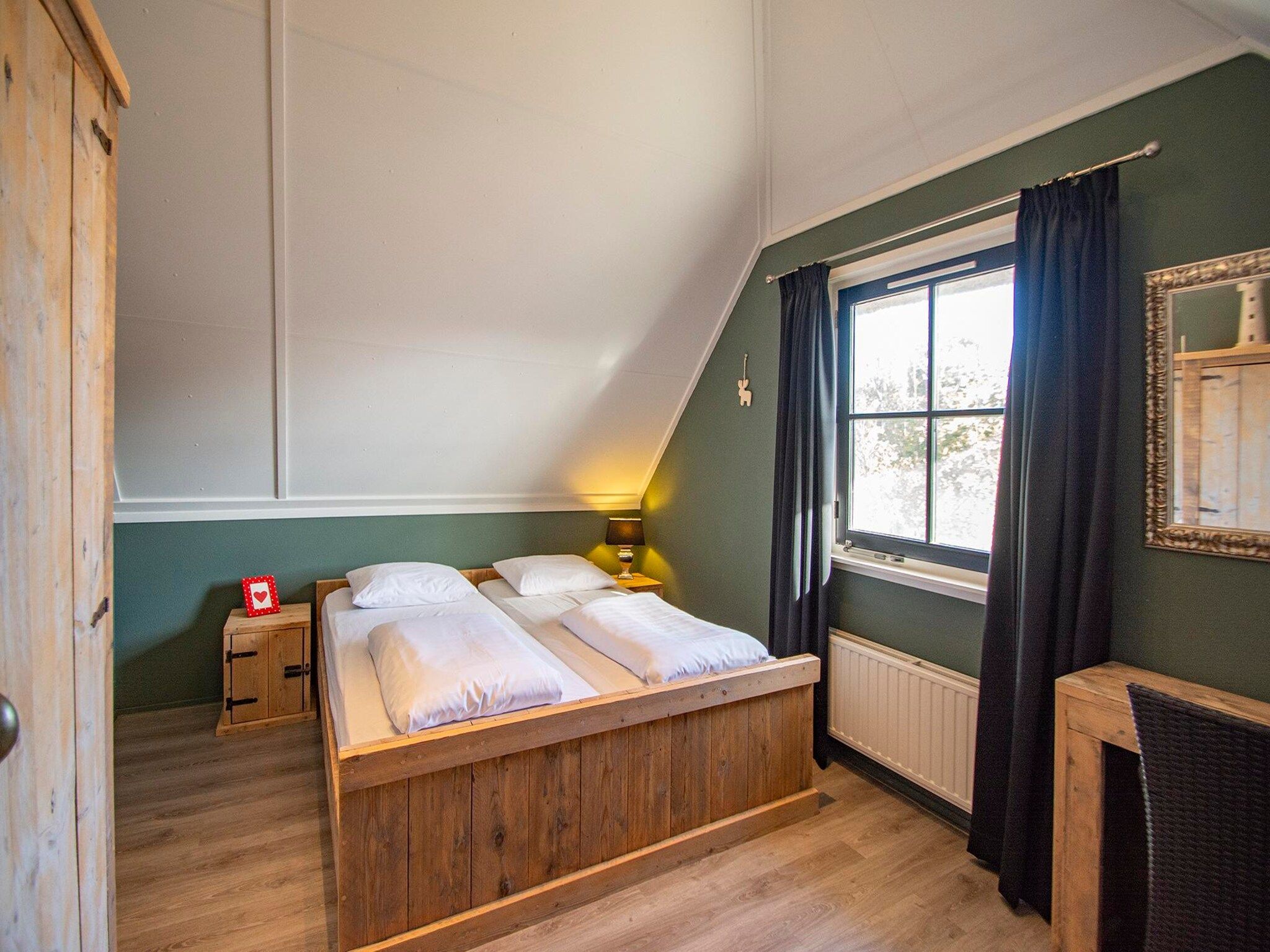 Een slaapkamer van De Buitenplaats 72 in Callantsoog