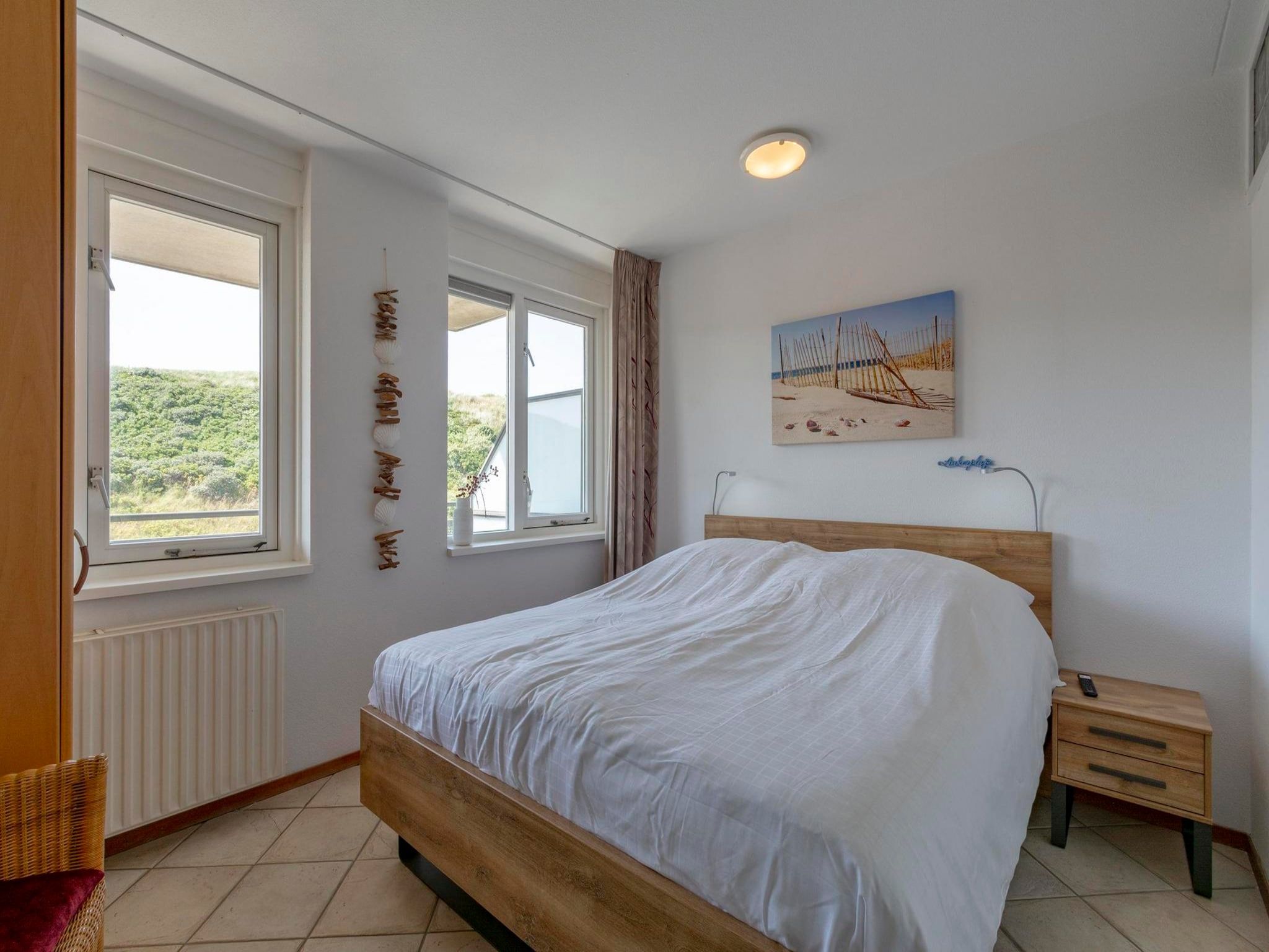 Een slaapkamer van Wijde Blick 211 in Callantsoog