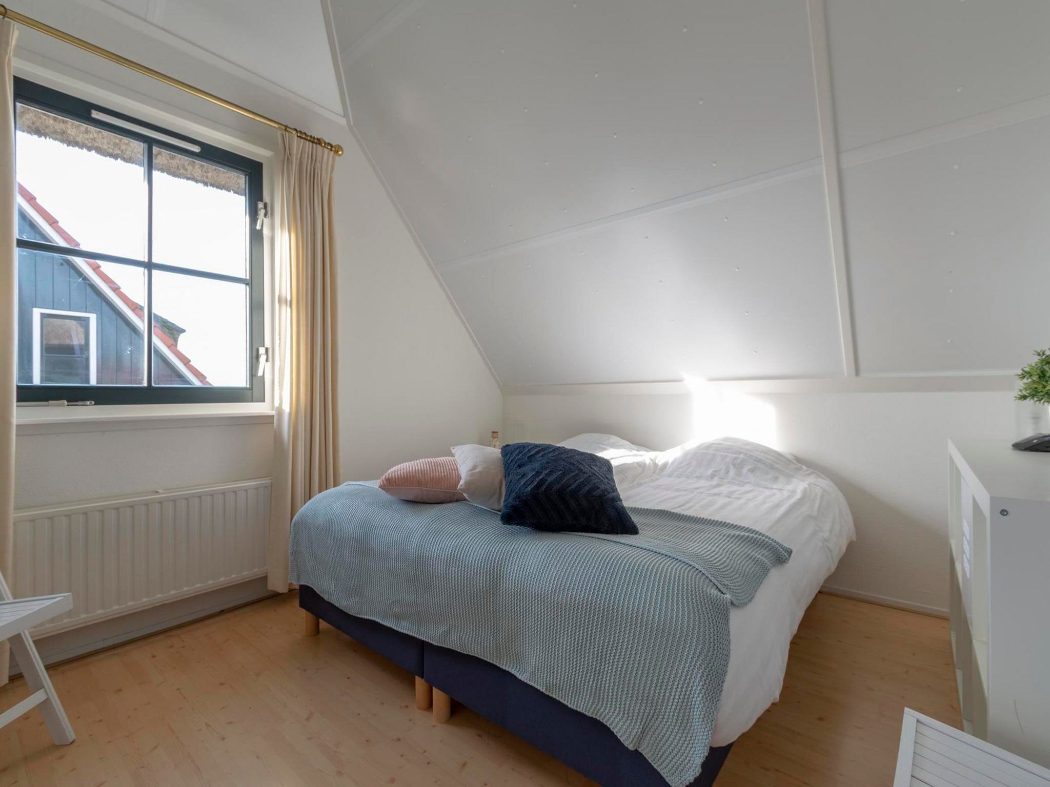 Een slaapkamer van De Buitenplaats 113 in Callantsoog