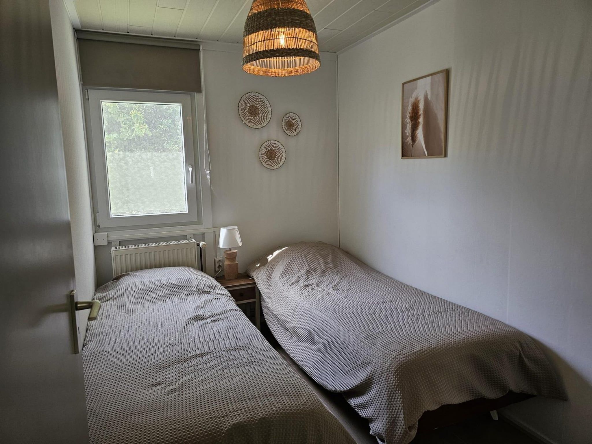 Een slaapkamer van Eb en Vloed 62 in Sint Maartenszee