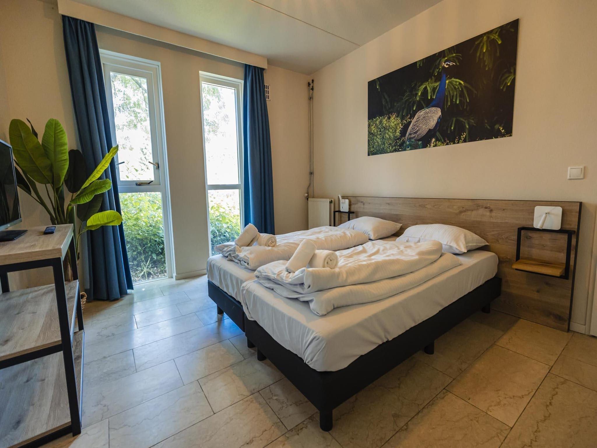 Een slaapkamer van 12 - Persons Family Bungalow in Ewijk