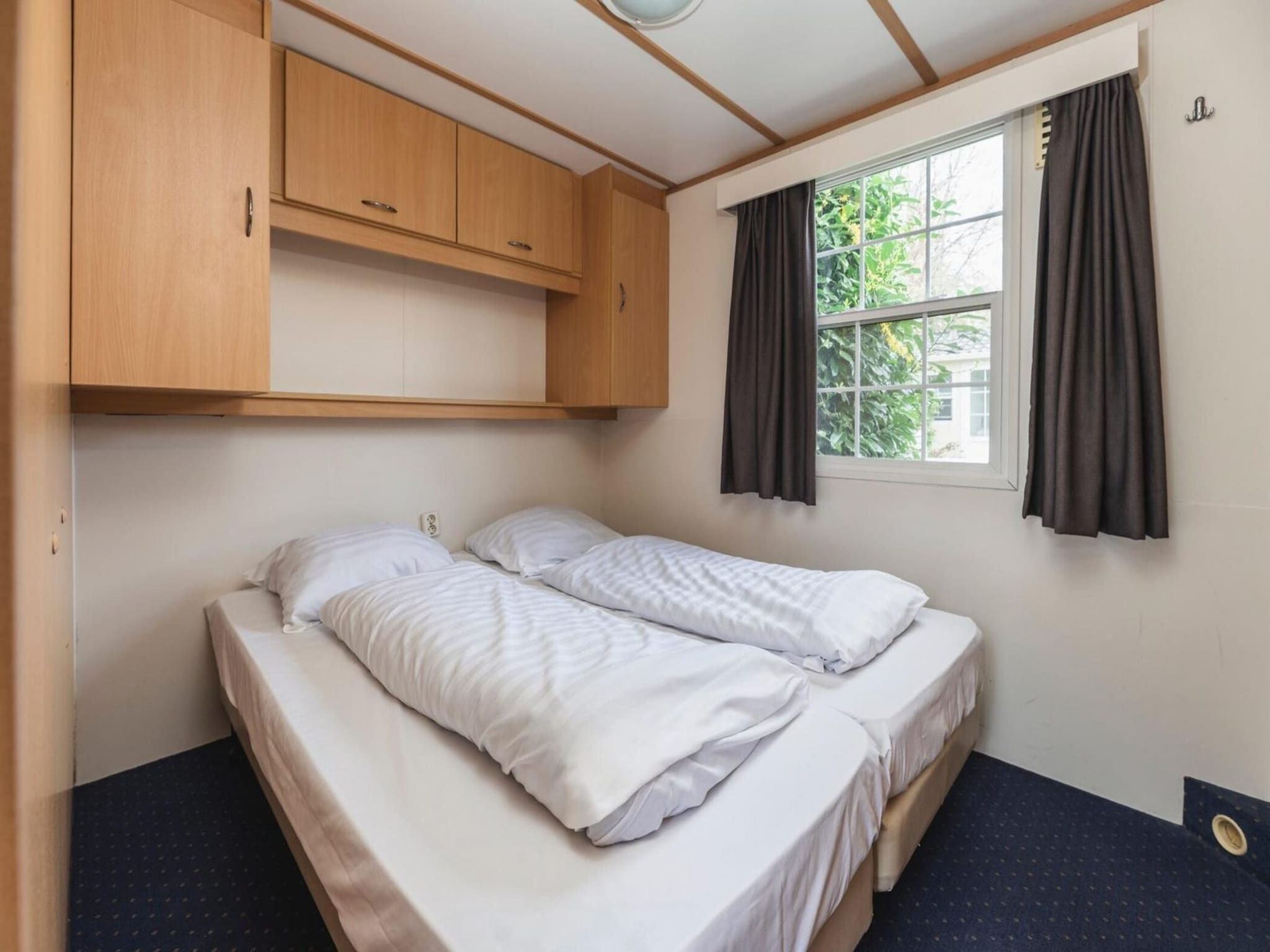 Een slaapkamer van Bungalow near the river I 4 persons in Zuna