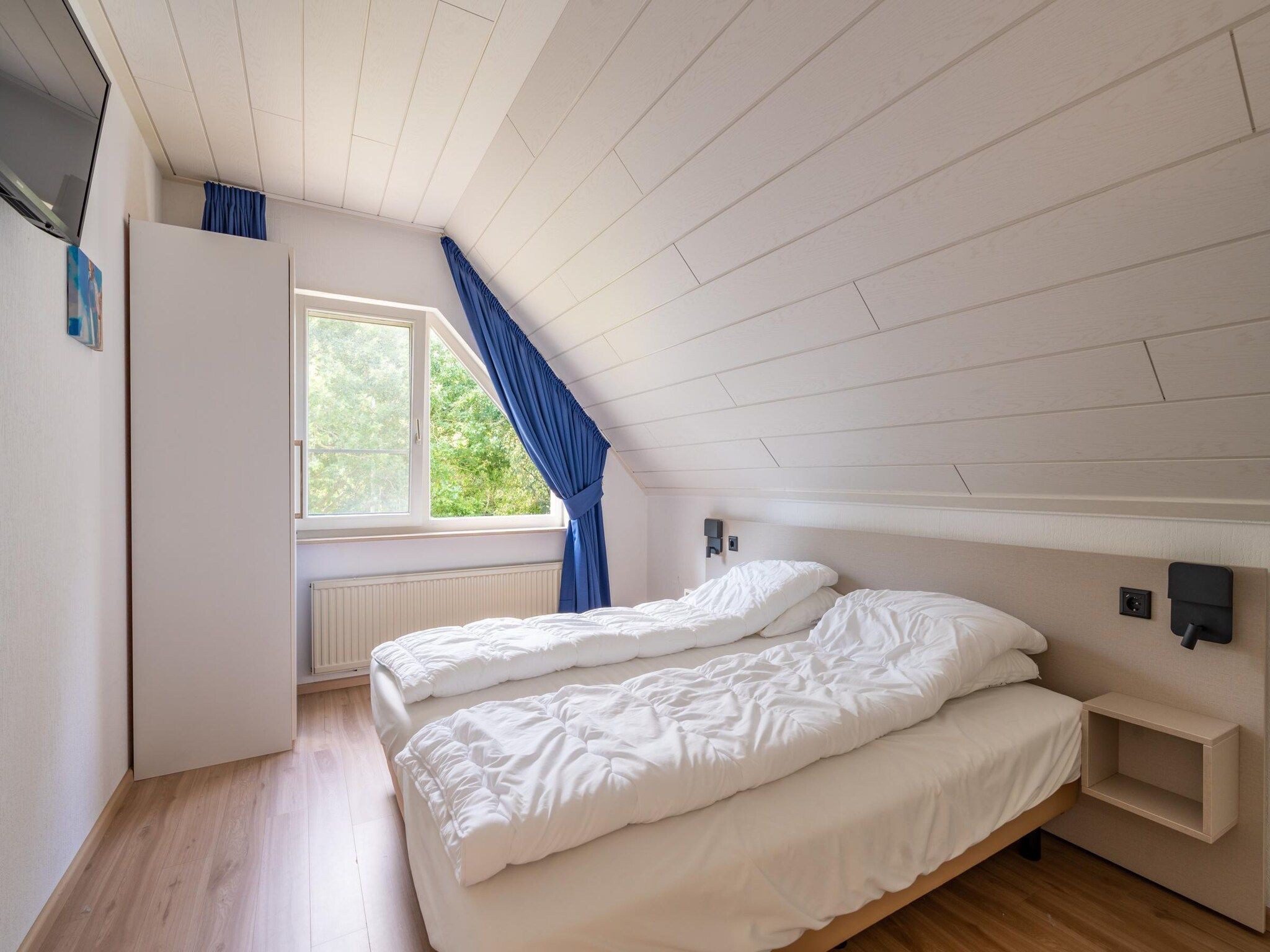 Een slaapkamer van Kamperfoelie 89 in De Koog