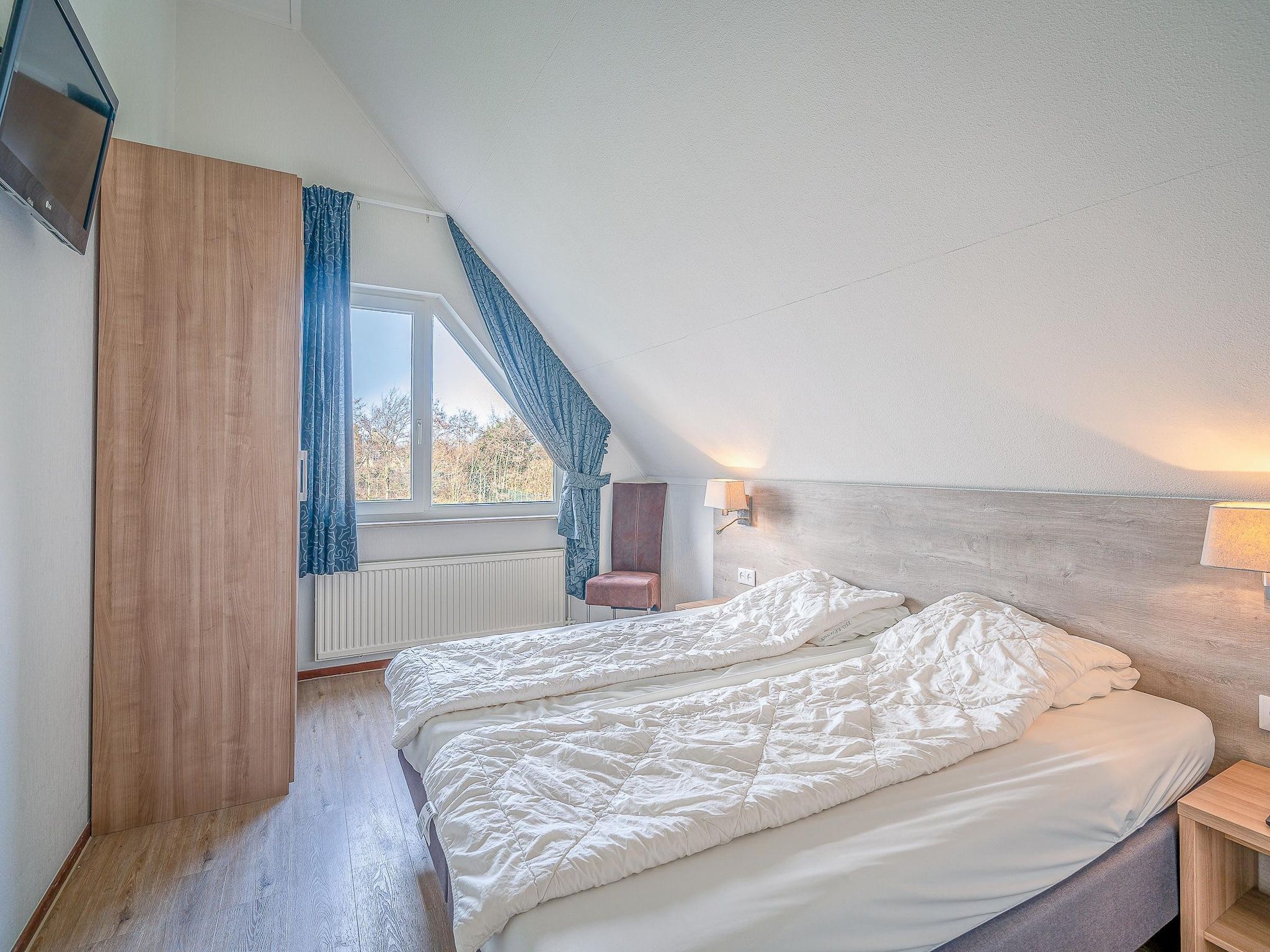 Een slaapkamer van Kamperfoelie 51 in De Koog