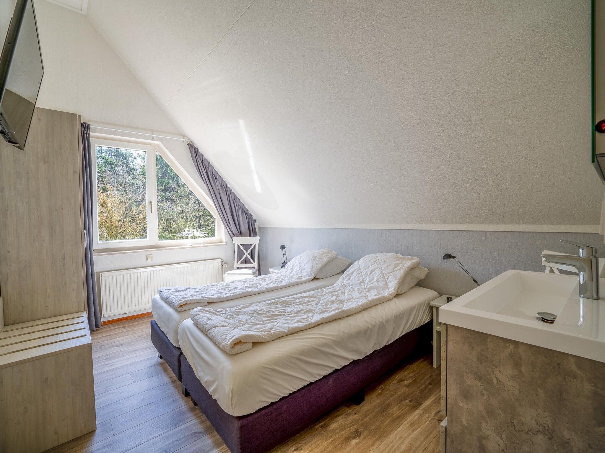 Een slaapkamer van Kamperfoelie 91 in De Koog