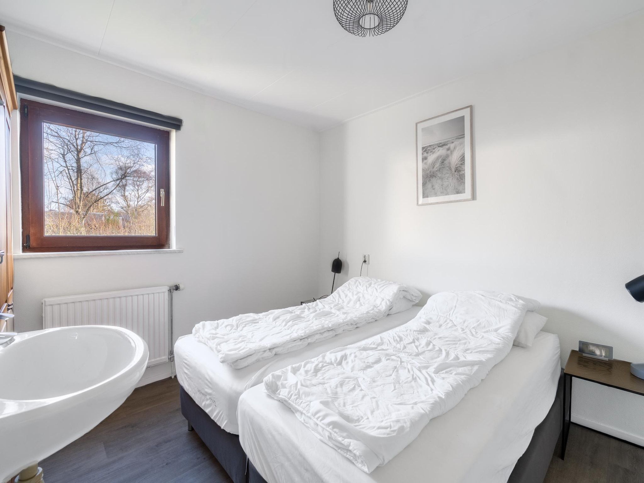 Een slaapkamer van De parel 164 in De Koog