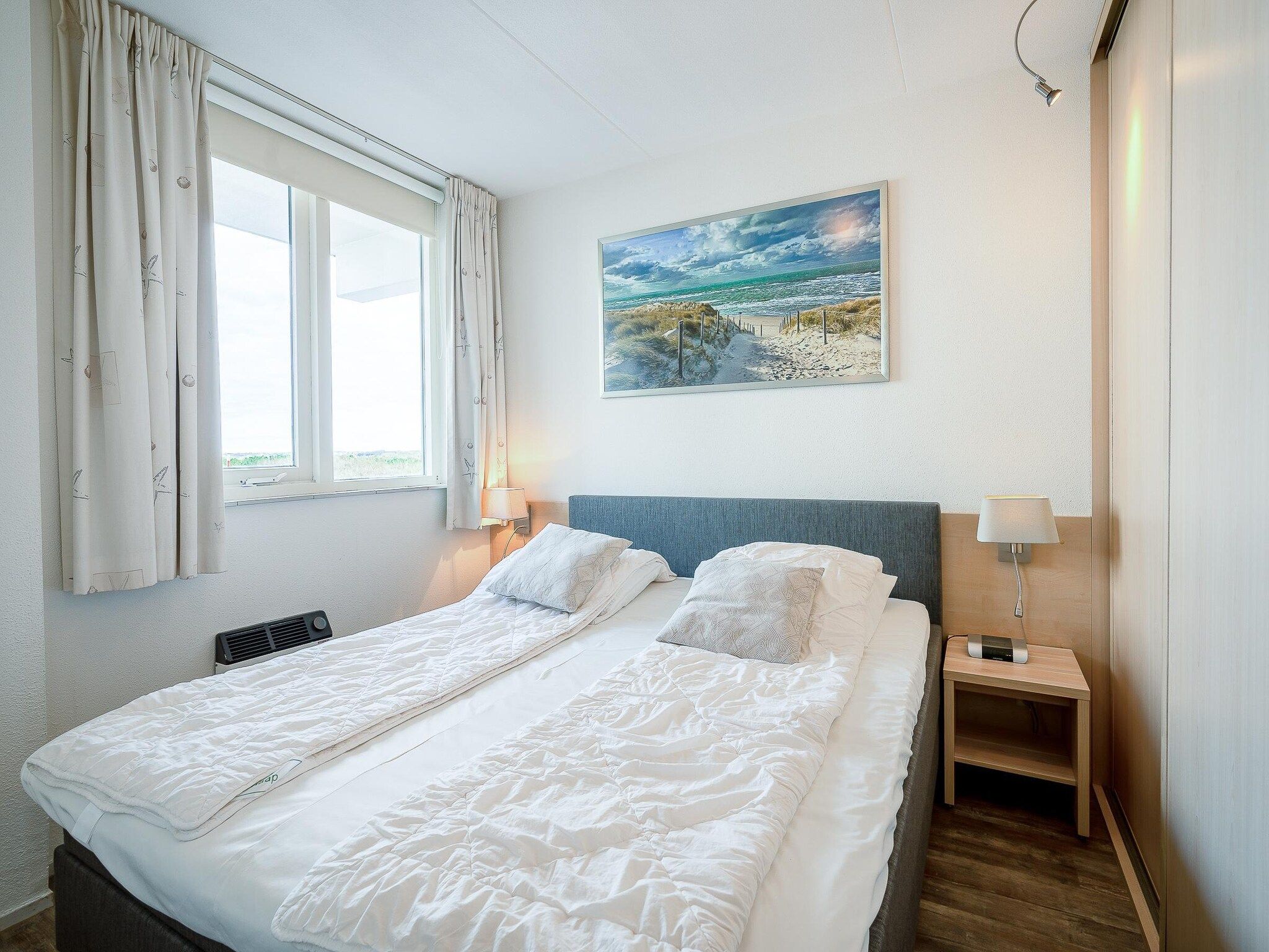 Een slaapkamer van Juliana 096 in De Koog