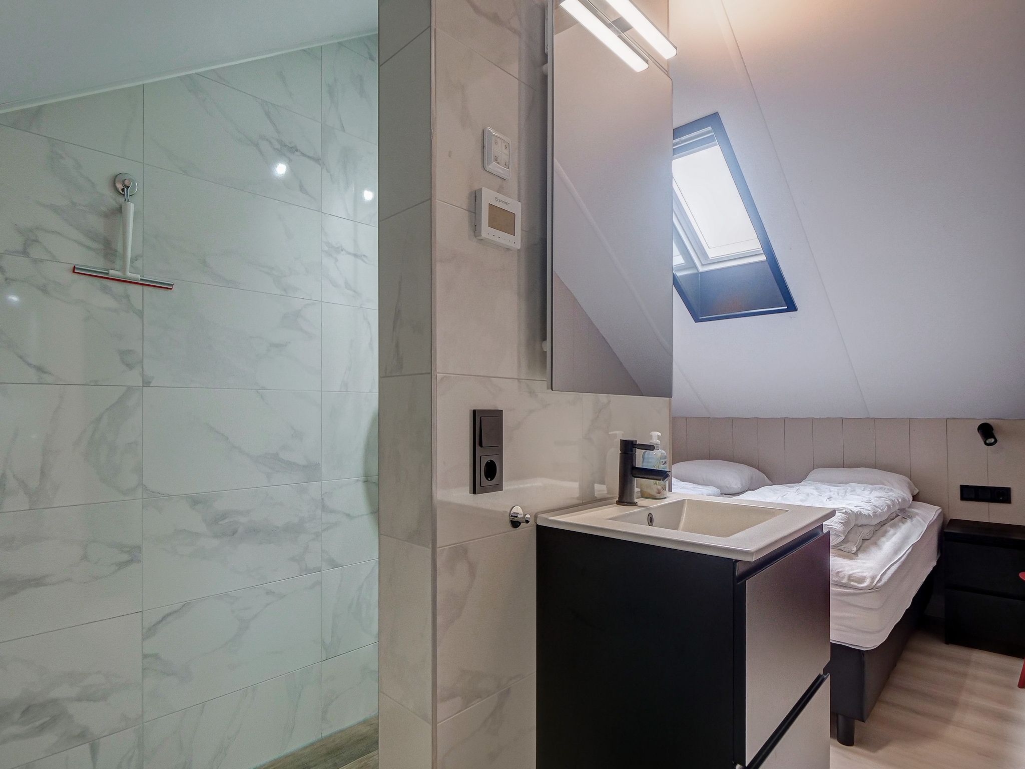 Een slaapkamer van Huis Zand in Julianadorp aan zee