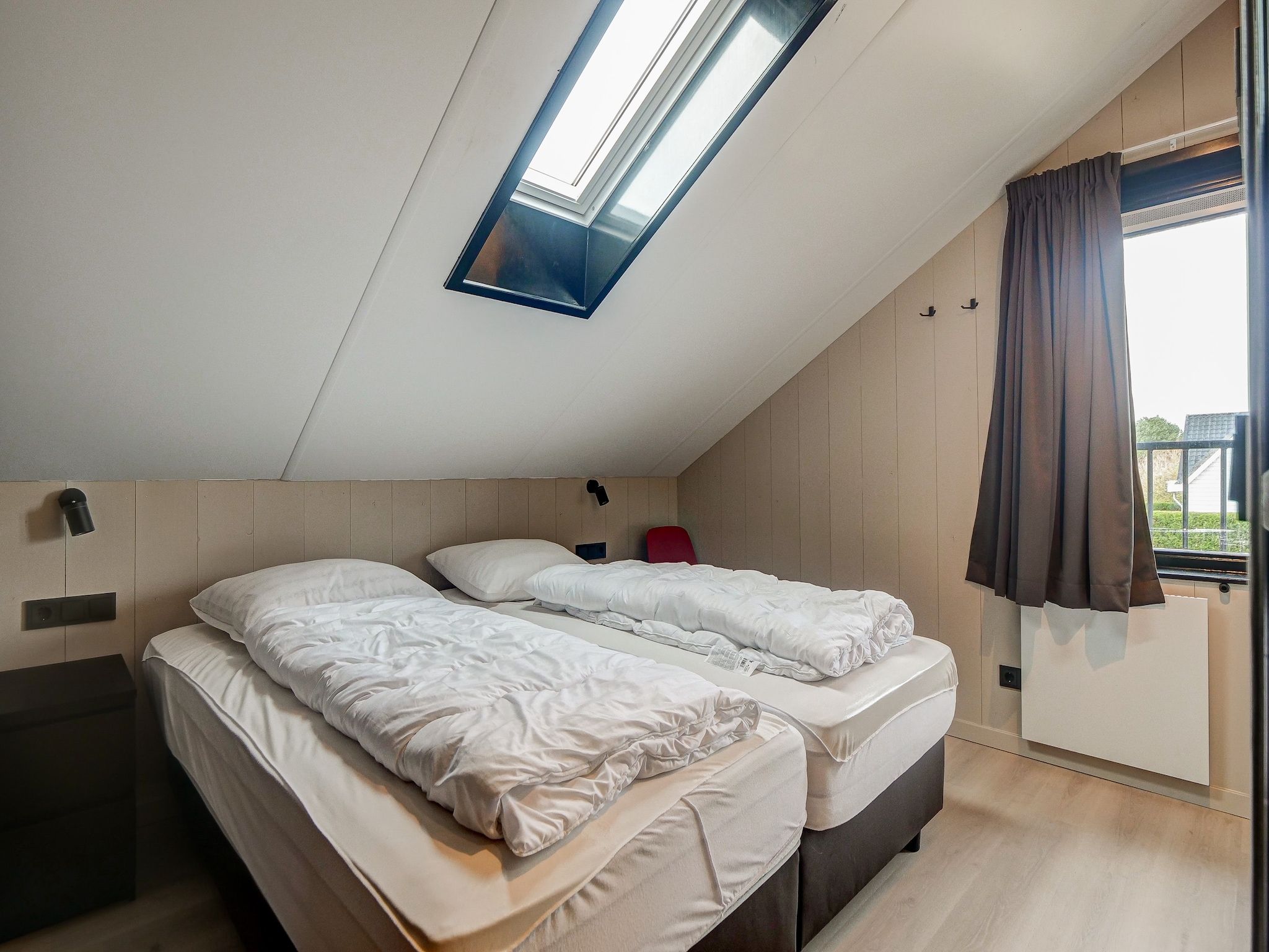 Een slaapkamer van Huis Zand in Julianadorp aan zee