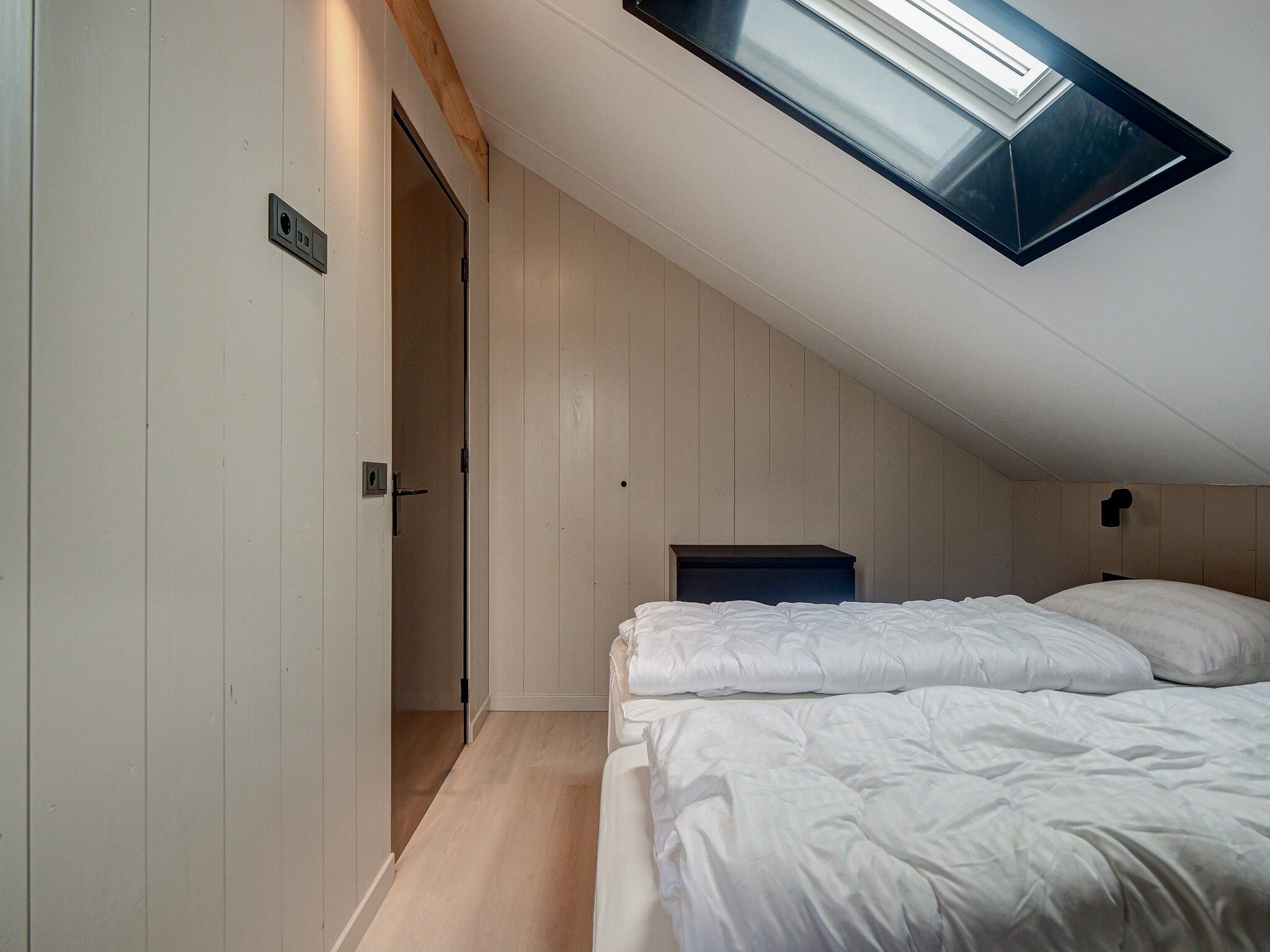 Een slaapkamer van Huis Zand in Julianadorp aan zee