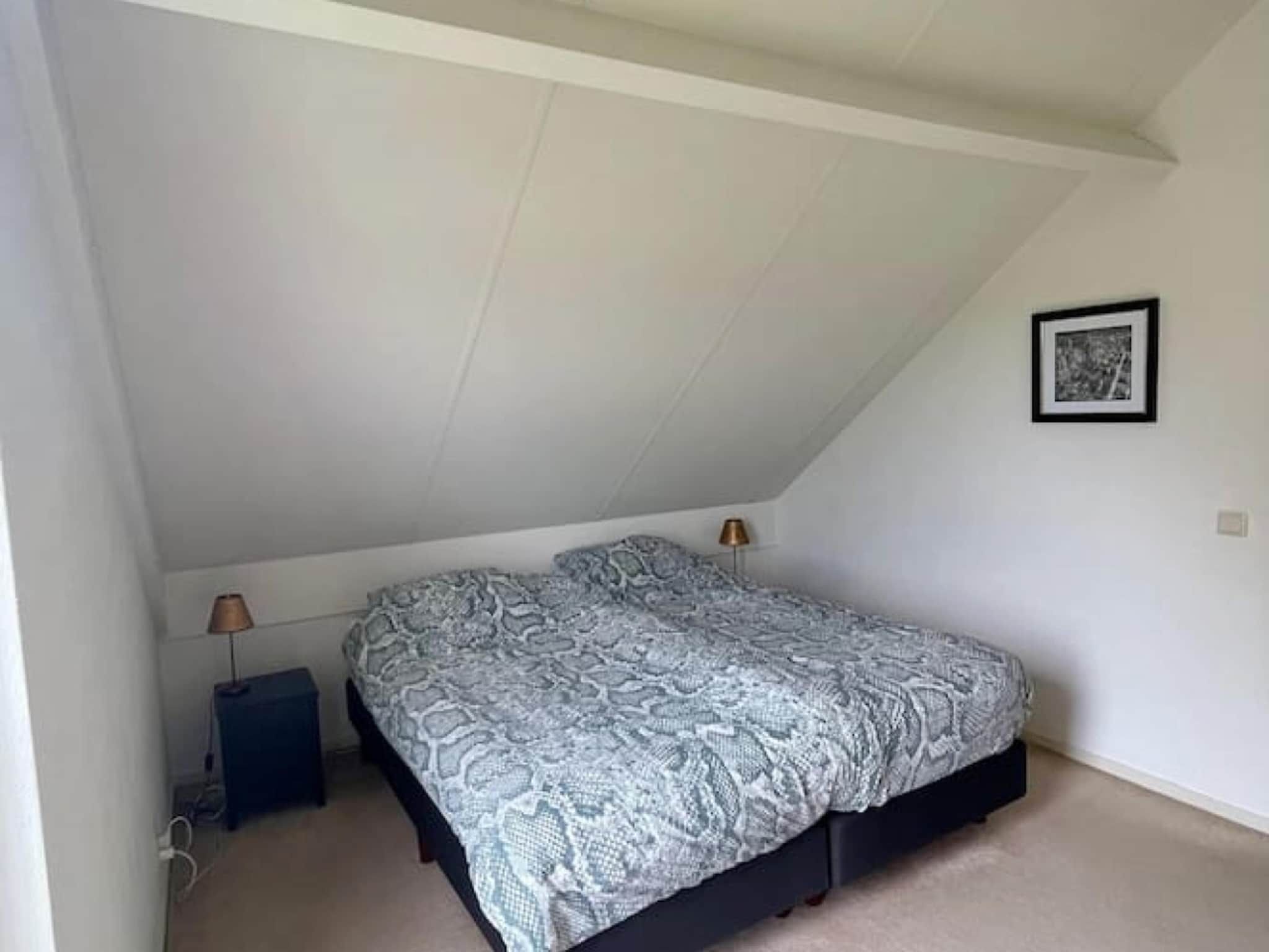 Een slaapkamer van 6 - Persons Forest Bungalow (copy) in Ewijk
