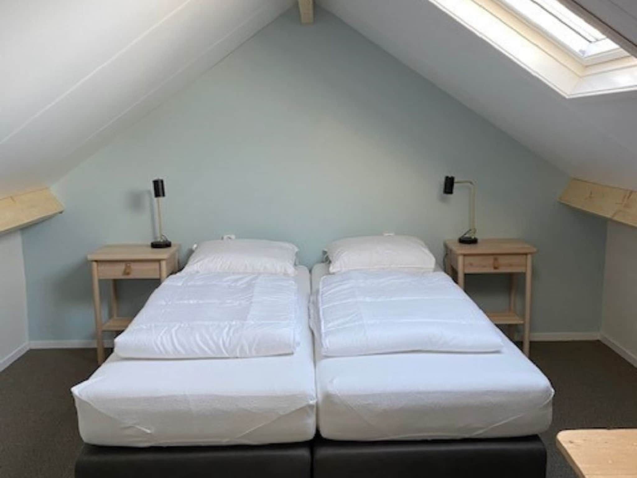 Een slaapkamer van Landgoed Eysinga State 2 in Sint Nicolaasga