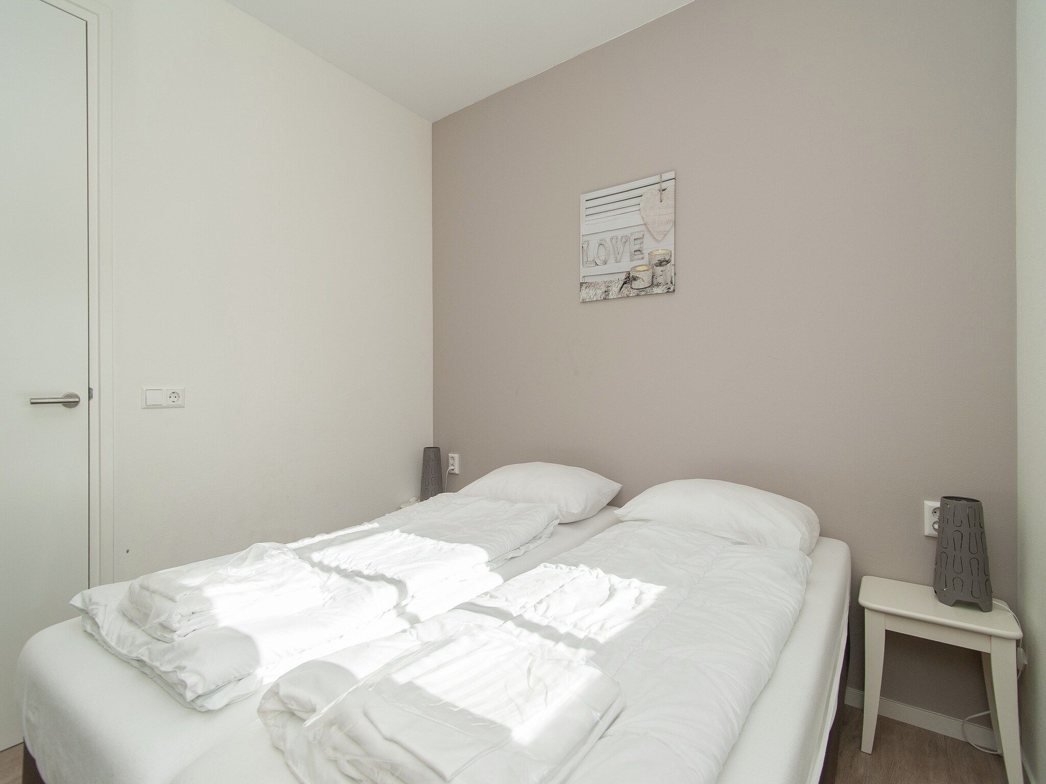 Een slaapkamer van Bungalowpark de Gouden Spar 3 in Noordwijk