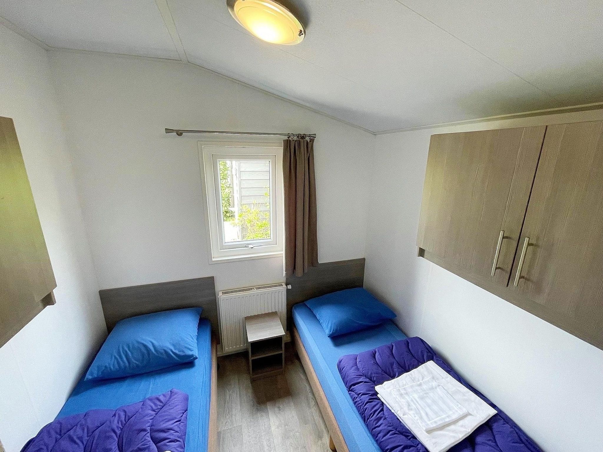Een slaapkamer van Vakantiepark de Tabaksschuur 2 in Elst