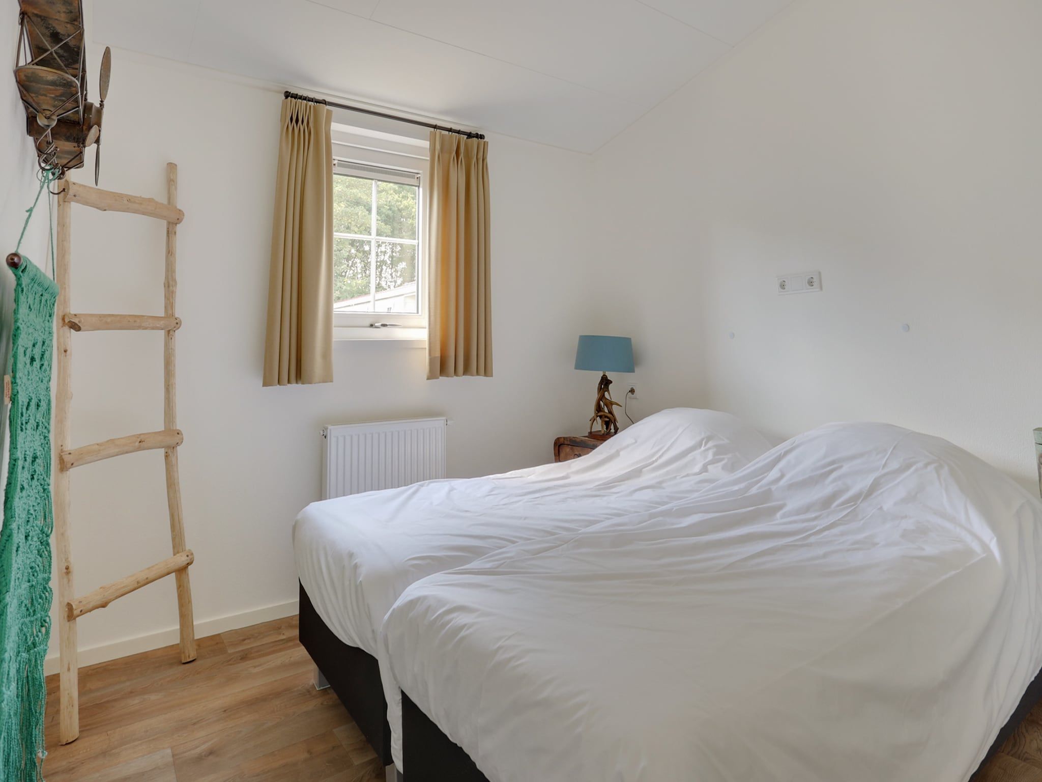 Een slaapkamer van Vakantiepark Sandberghe 6 in Uden