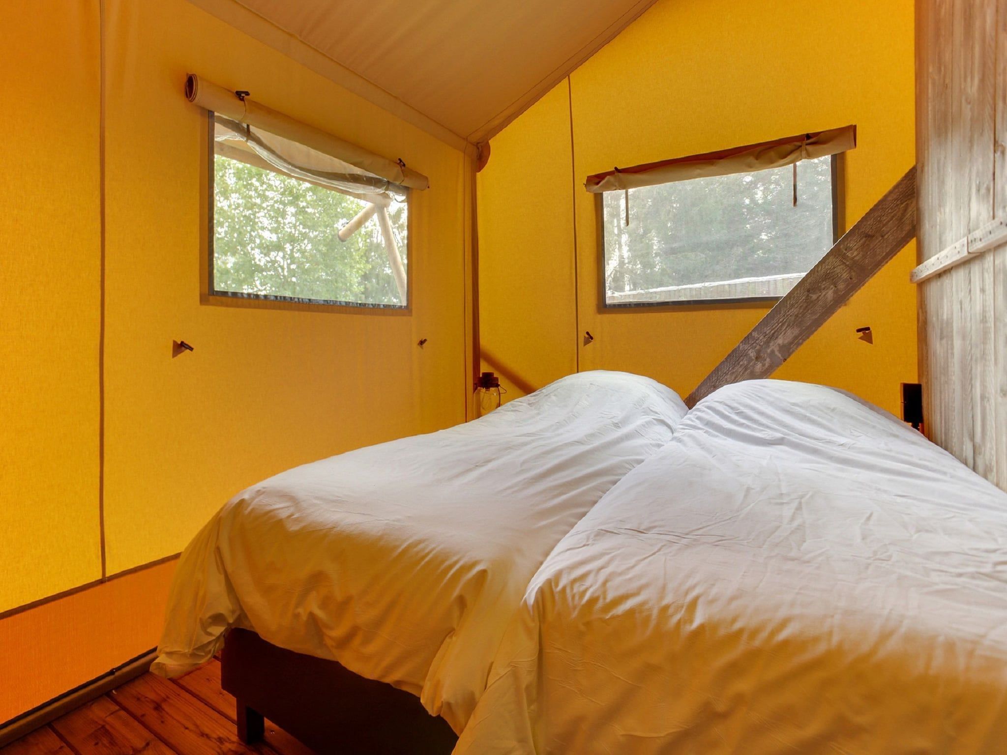 Een slaapkamer van Vakantiepark Sandberghe 11 in Uden
