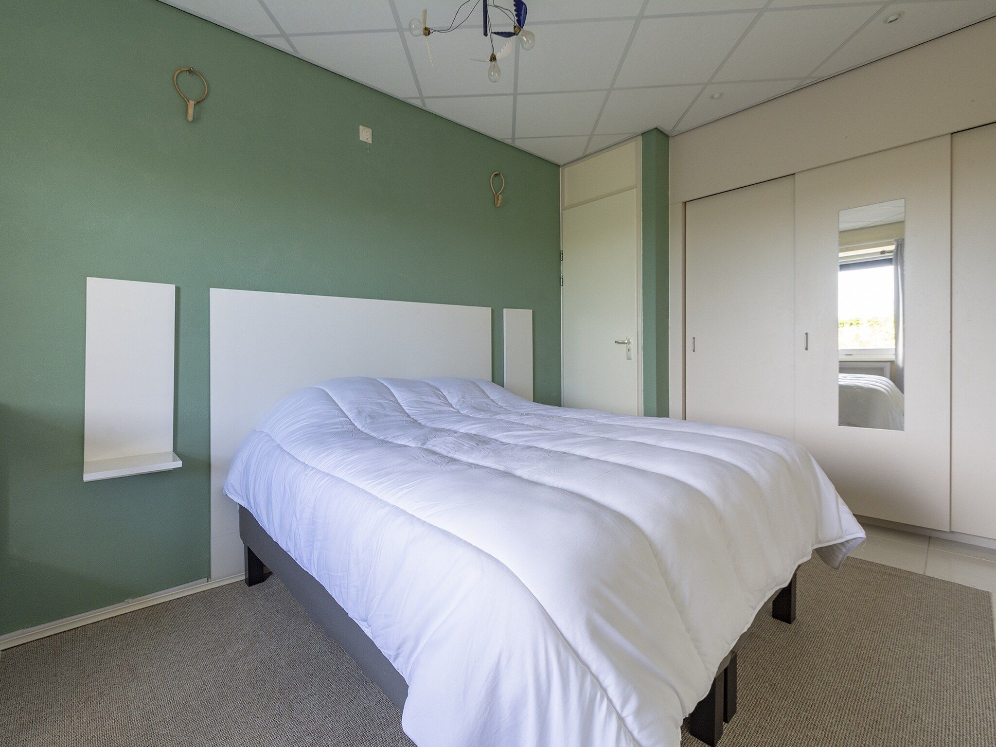 Een slaapkamer van Strandslag 115 in Julianadorp aan Zee