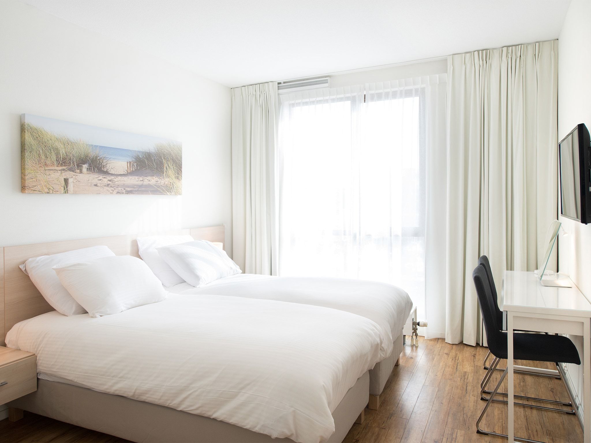 Een slaapkamer van Scheveningen Harbour 58C in Den Haag