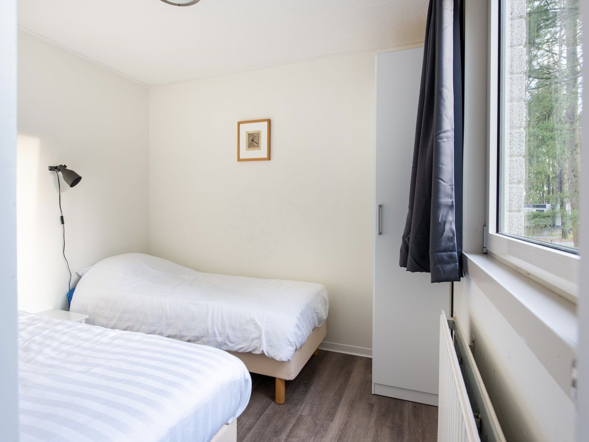 Een slaapkamer van Vakantiepark de Berkenhorst 11 in Kootwijk