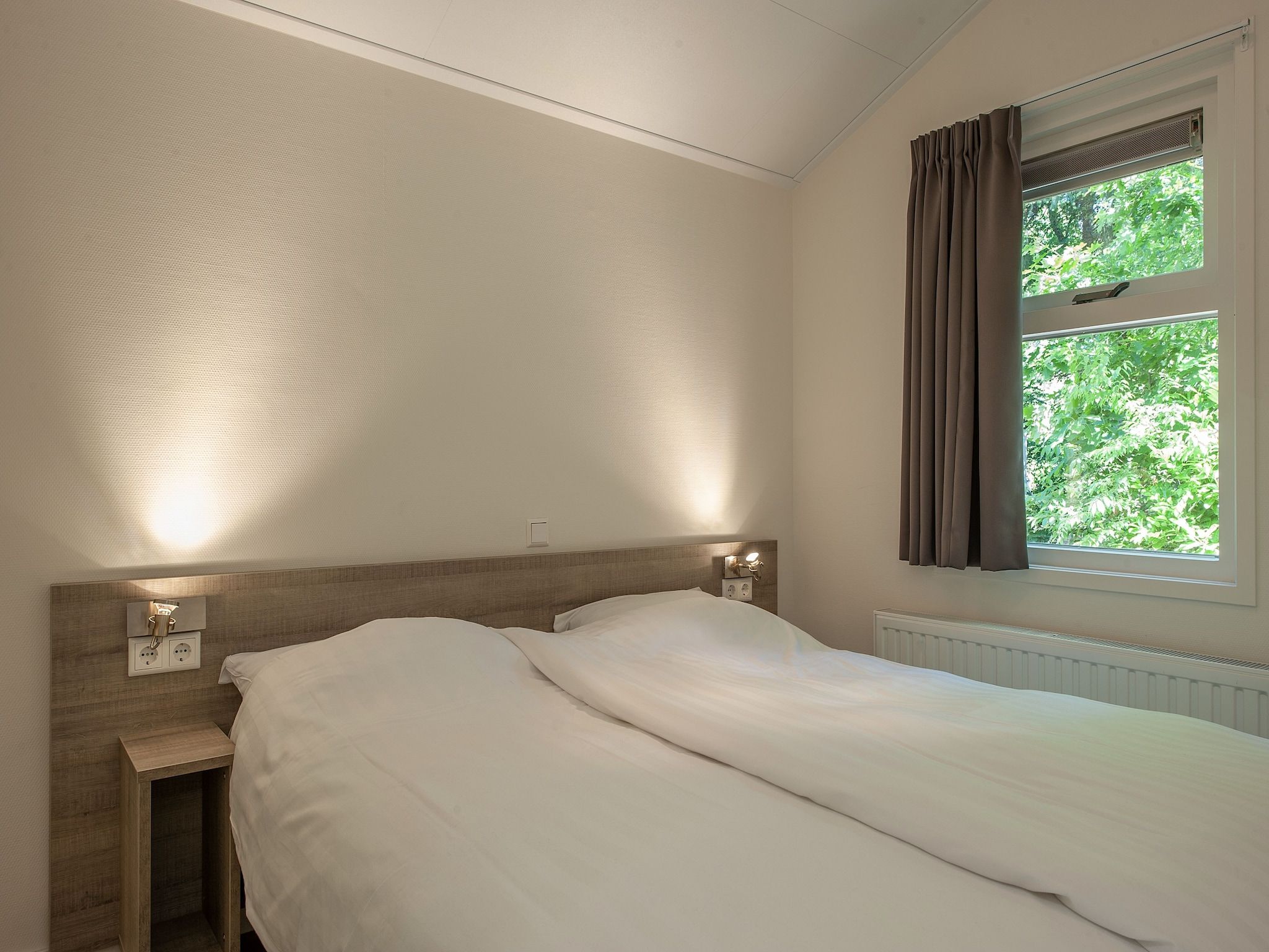 Een slaapkamer van Bospark de Schaapskooi 9 in Wissel/Epe