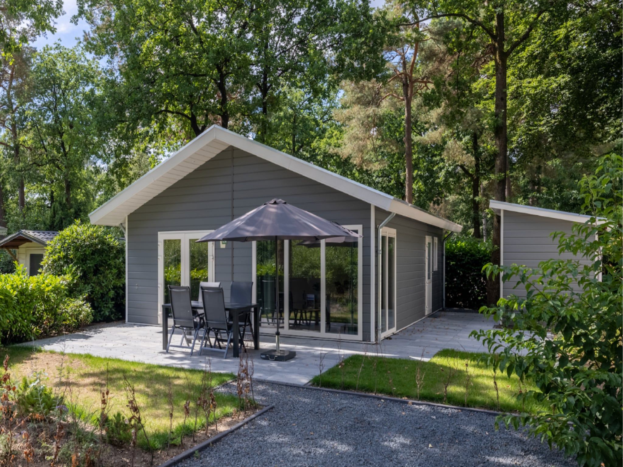 Het terras van Vakantiepark De Rimboe & De Woeste Hoogte 21 in Hoenderloo