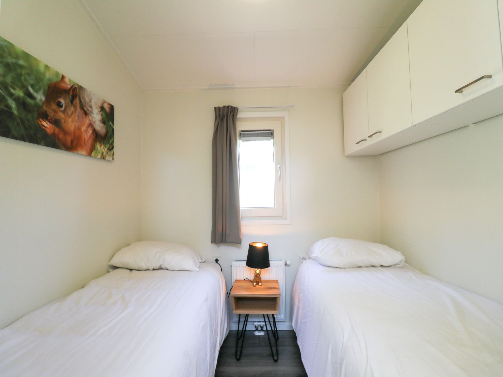 Een slaapkamer van Vakantiepark De Rimboe & De Woeste Hoogte 22 in Hoenderloo
