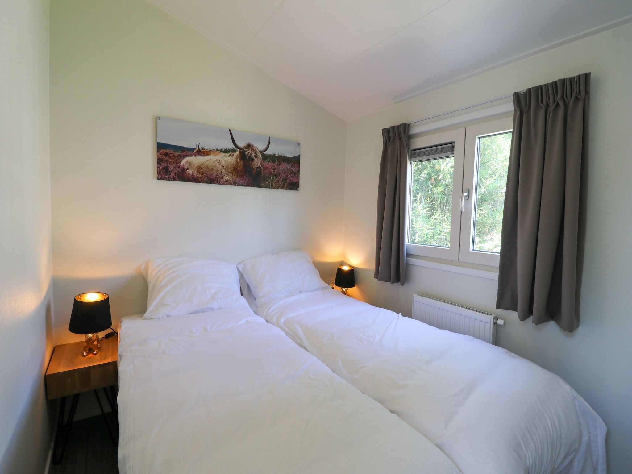 Een slaapkamer van Vakantiepark De Rimboe & De Woeste Hoogte 22 in Hoenderloo
