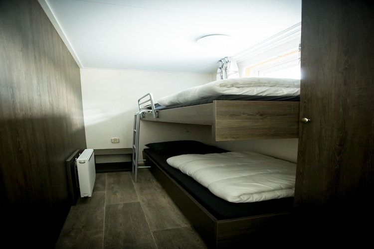 Een slaapkamer van Recreatiepark Duinhoeve 14 in Udenhout